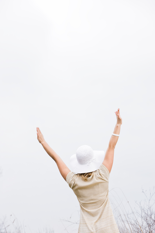 lady-with-outstretched-hands-white-hat