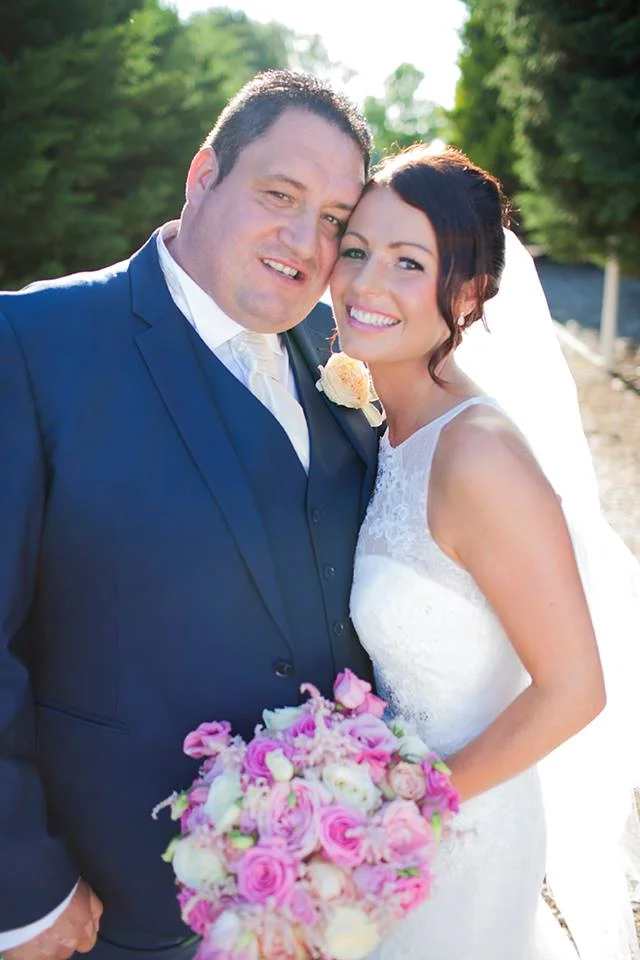 Claire and Mark cheeks together.jpg