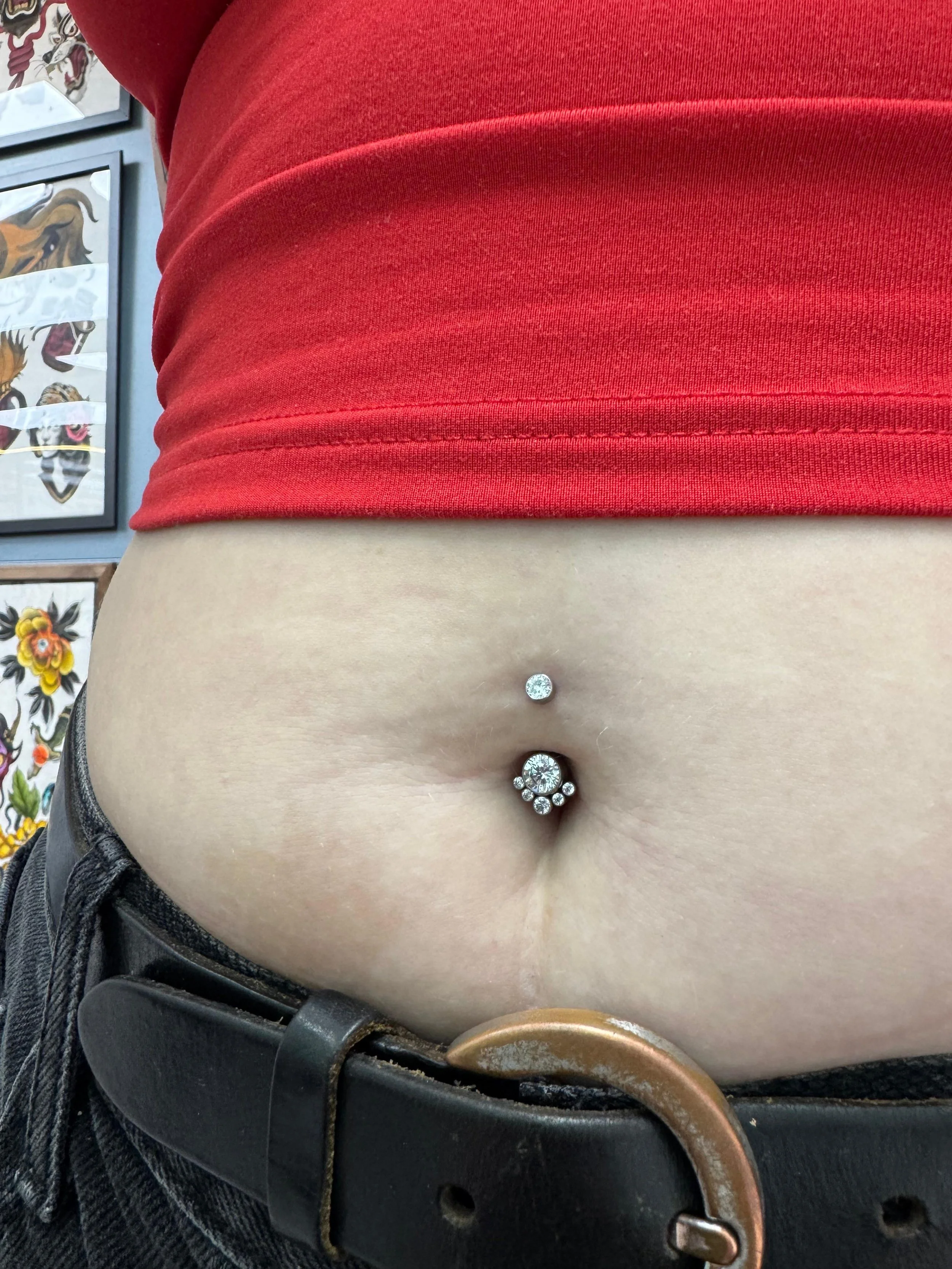 An image of a navel piercing done at Kilburn Original done with a gem cz titanium navel bar