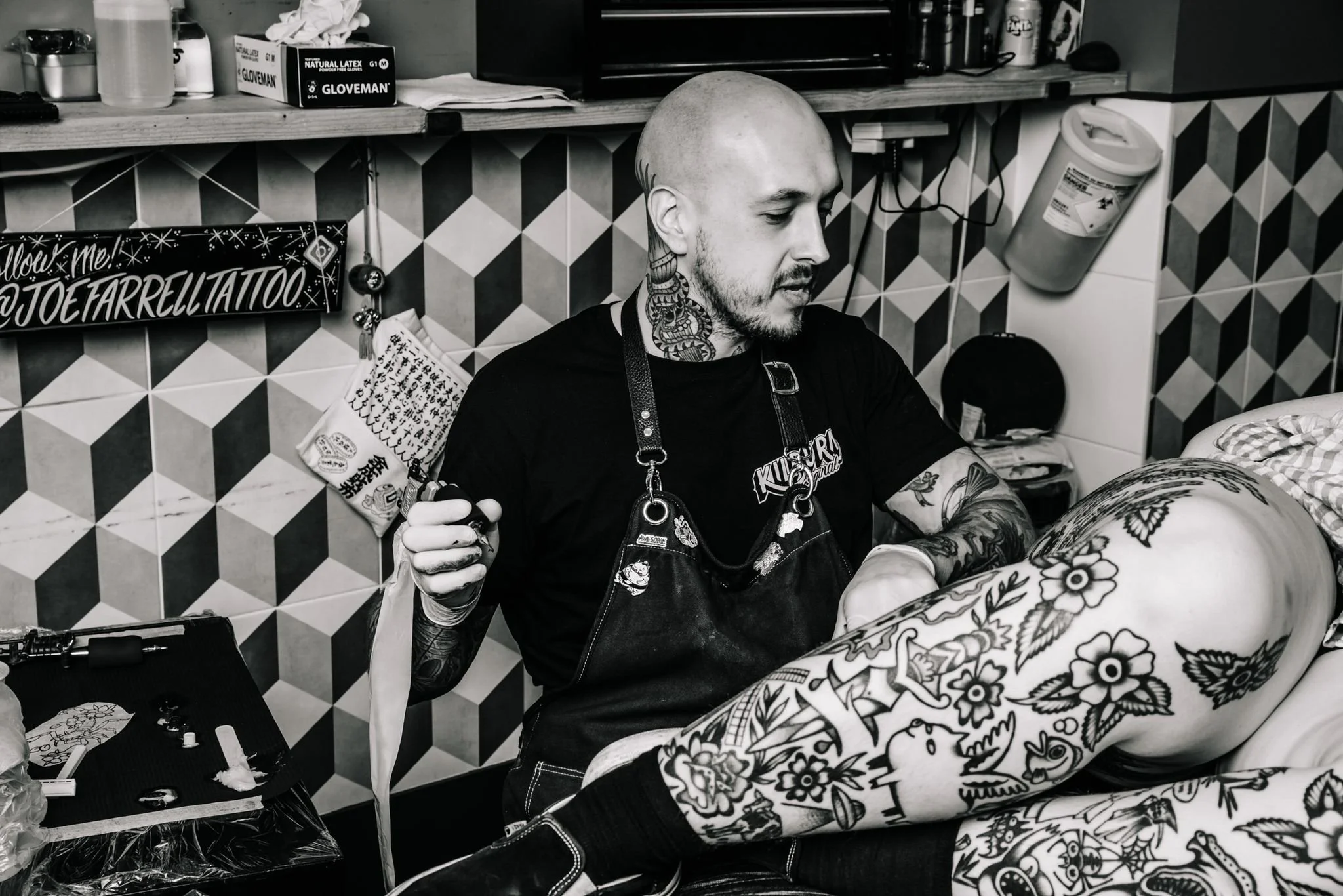 Japanese specialist Joe Farrell tattooing in London. Photo taken while working on a leg piece at Kilburn Original