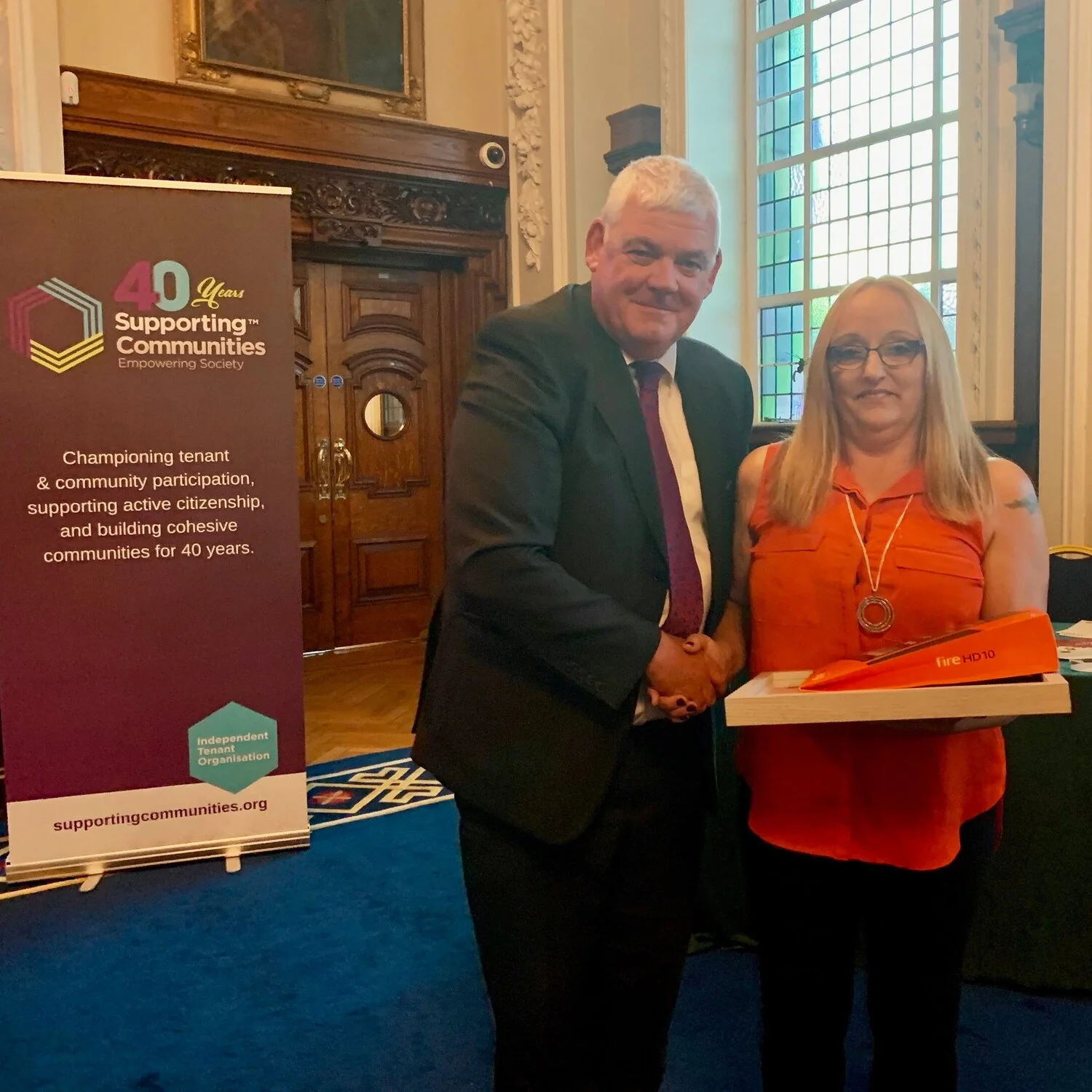 Andrea Whiltshaw recieves the “Excellence in Learning” Award presented by Colm McQuillan from the Housing Executive.