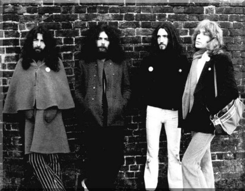 Edgar Broughton Band, in front of a wall. 