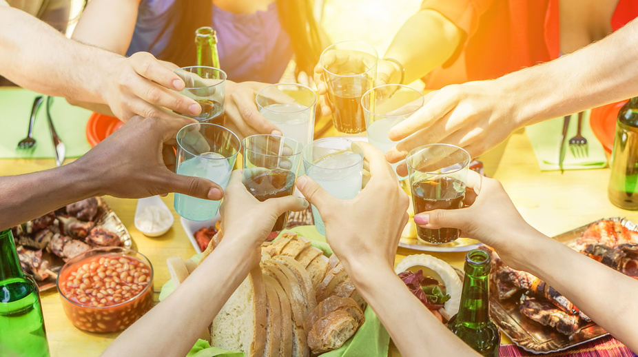 Group of friends toasting with aperitif eating barbecue outdoor