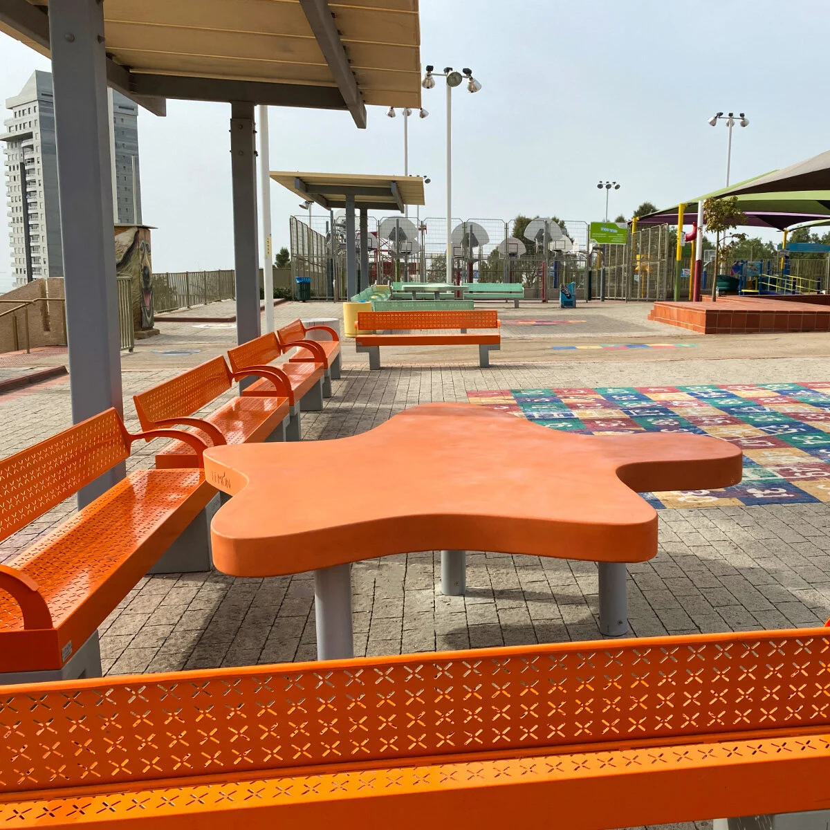 ספסלים ארוכים מסדרת Salerno בצבע טורקיז עם רגלי בטון אדריכלי, מרחב ציבורי באשדוד