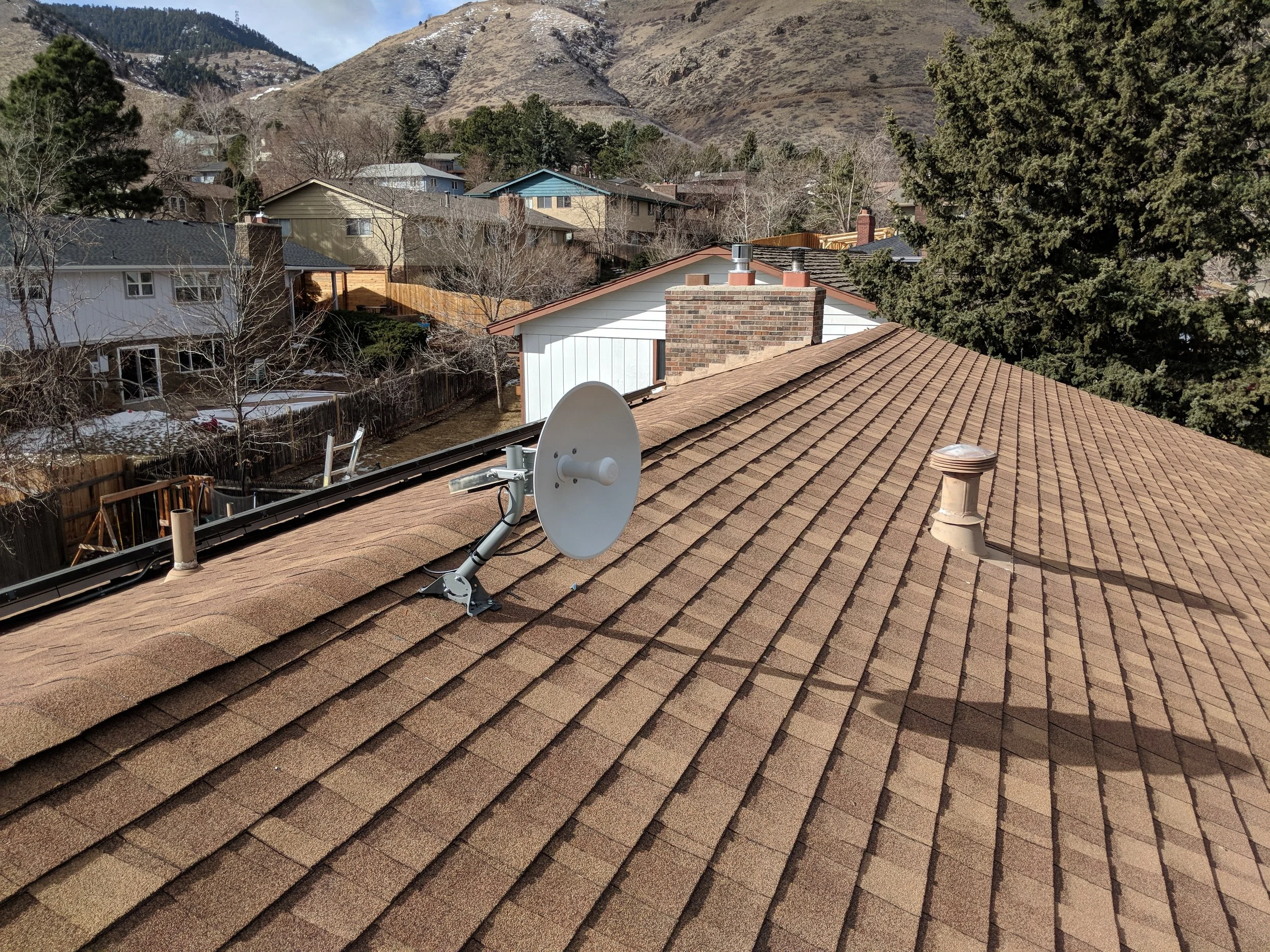 Dish radio mounted to a j-bar attached to the roof