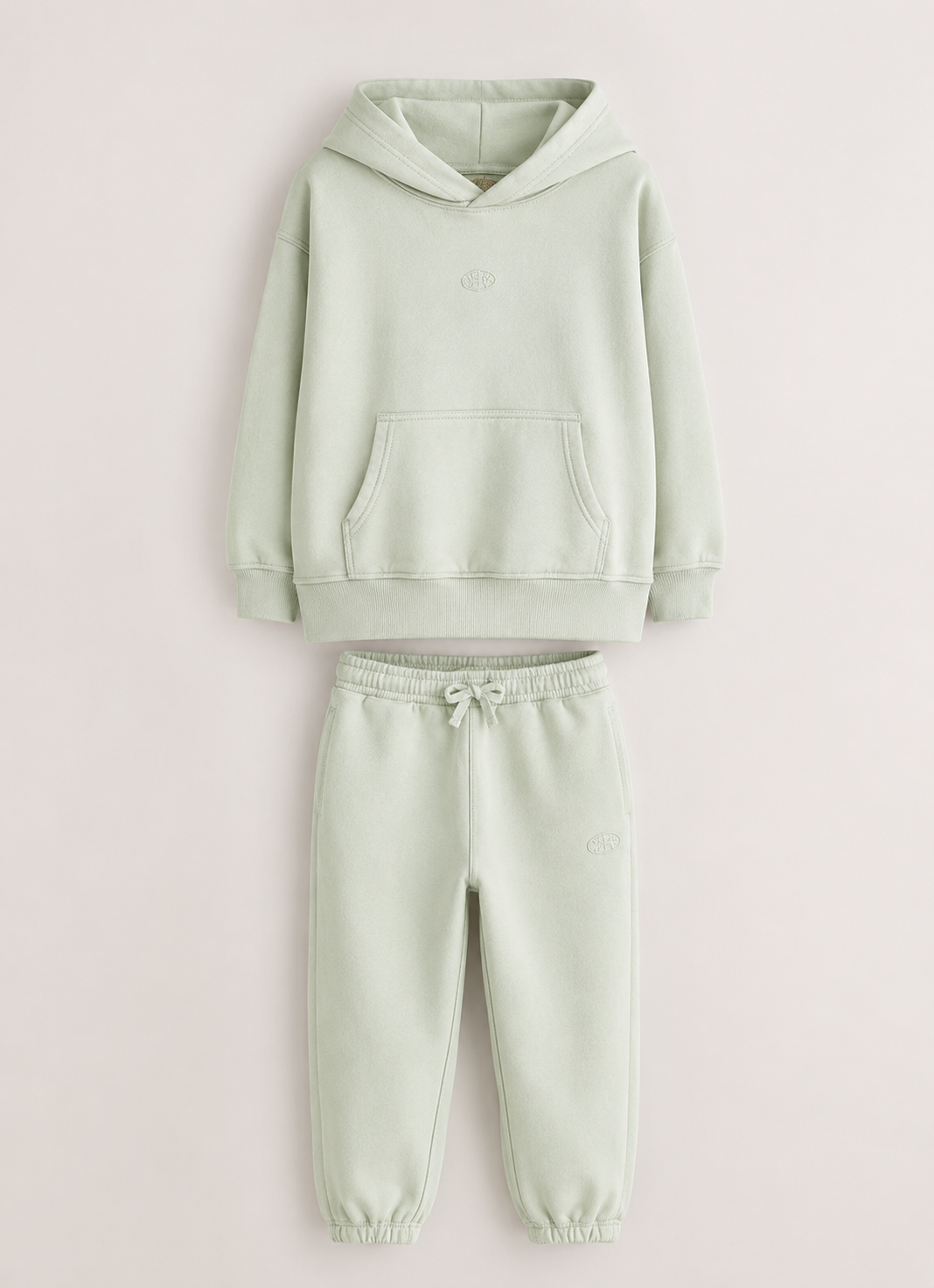 Light green hoodie and sweatpants set on a white background. /  E-Commerce Flat-Lay