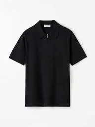 Black polo shirt with short sleeves and a collar. /  E-Commerce Flat-Lay