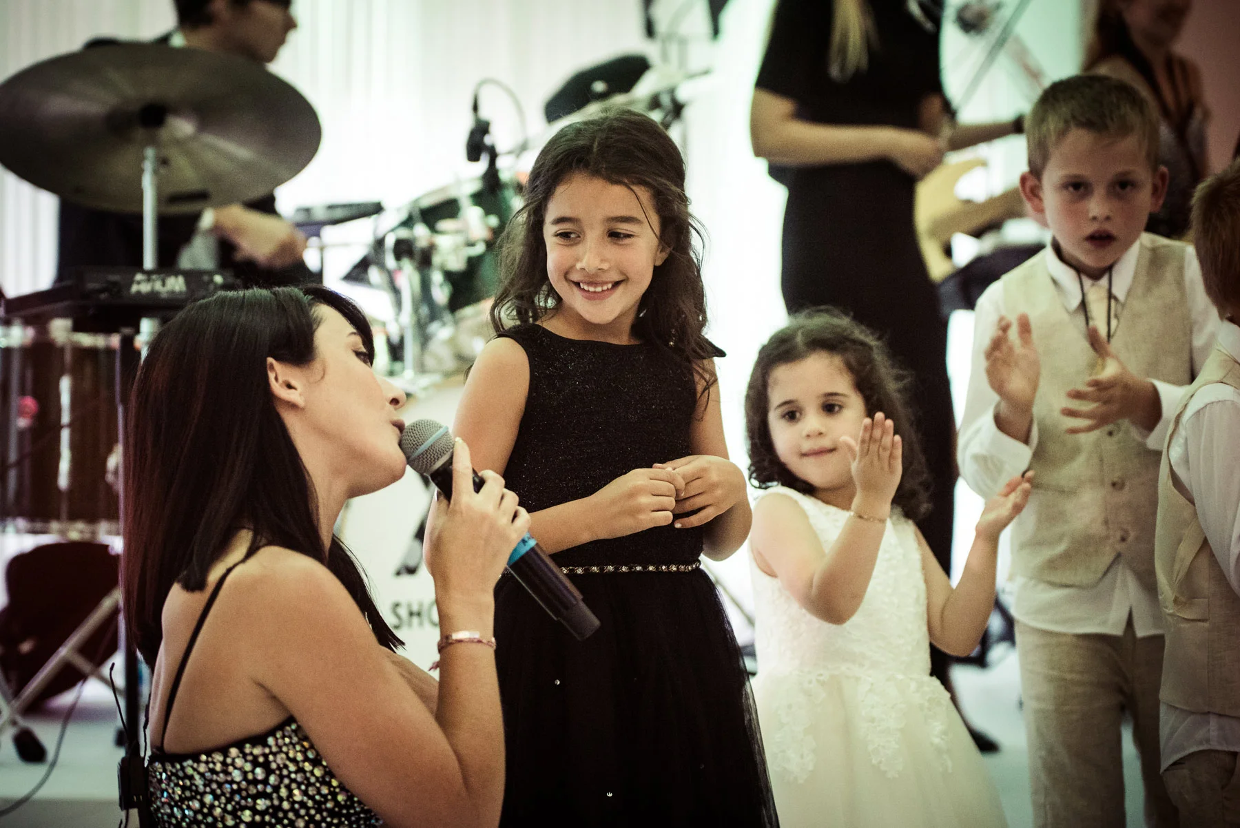 Female vocalist singing to girl