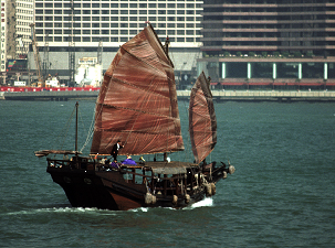 Image 1 is the source image with a base grade applied. The traditional junk gets confused with the modern background, so color enhancement is needed to emphasize the beauty of the boat and to compare it against the architecture.