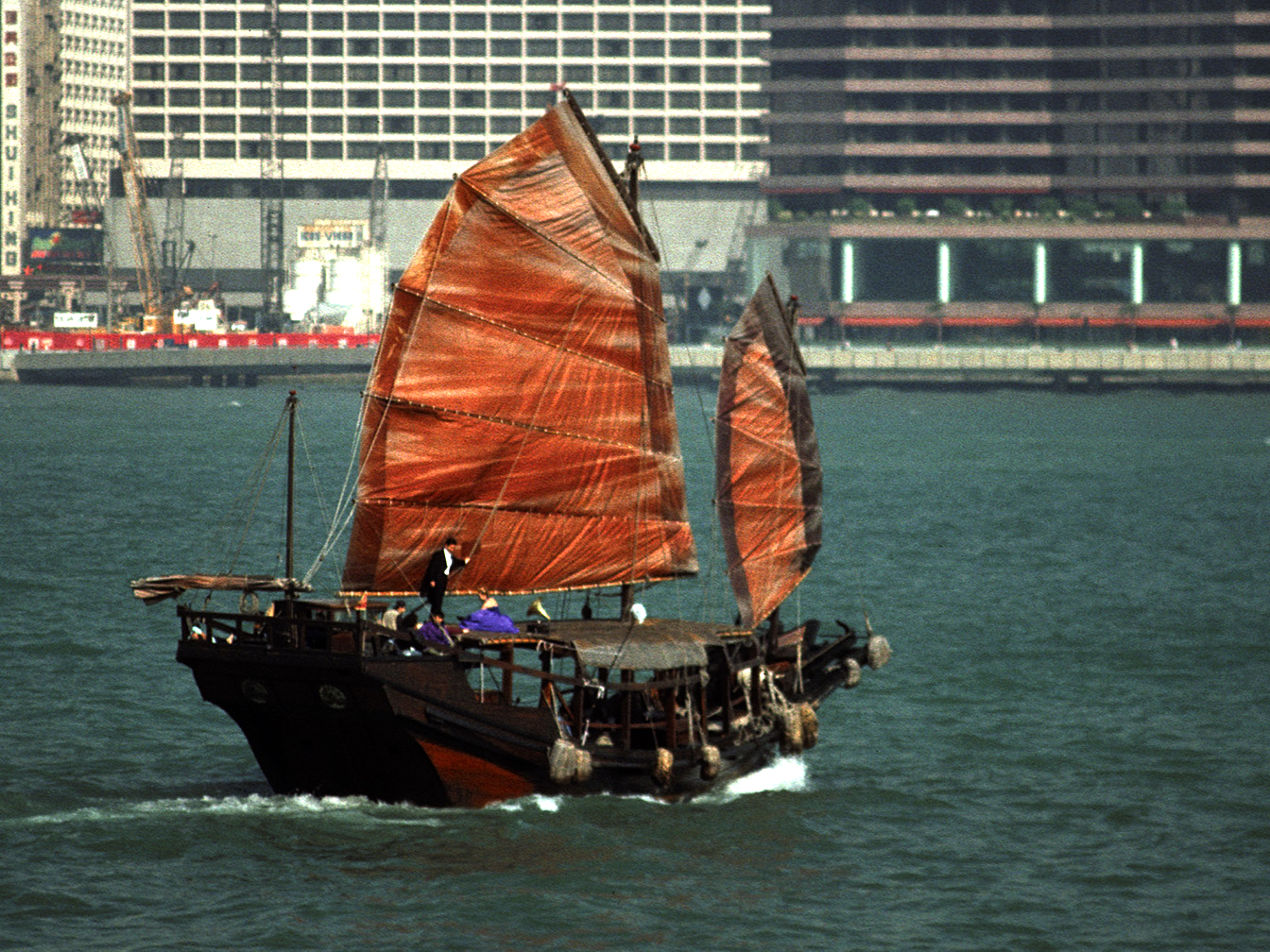 Image 2 shows the same image with secondary correction. The red of the sails and wooden hull are isolated and enriched using an HSL matte. Since the isolation is color based it does not need tracking. The extra color helps bring the junk forward in the picture, separating it from the background.