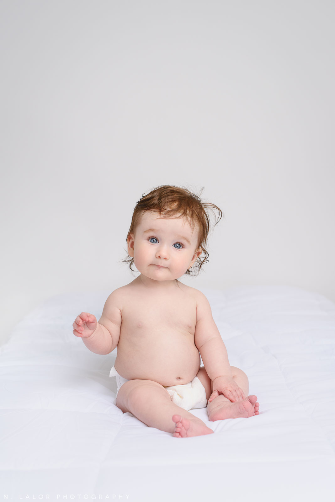 Adorable 6-month old baby girl, simple portrait. Family photo session by N. Lalor Photography. Studio located in Greenwich Connecticut.