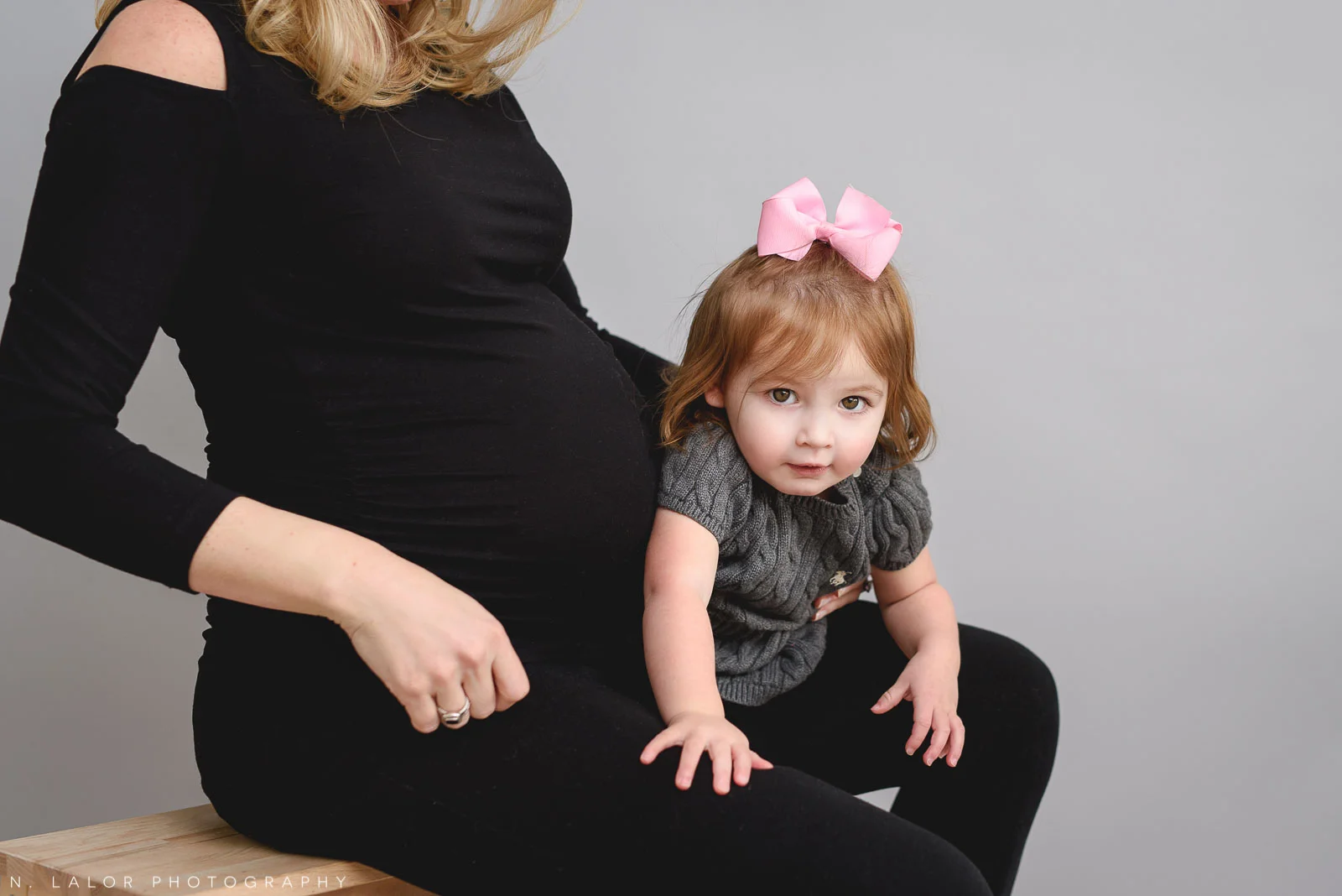 Soon to be big sister, with the baby bump. Maternity “Mom and Me” photo session by N. Lalor Photography. Studio located in Greenwich Connecticut.