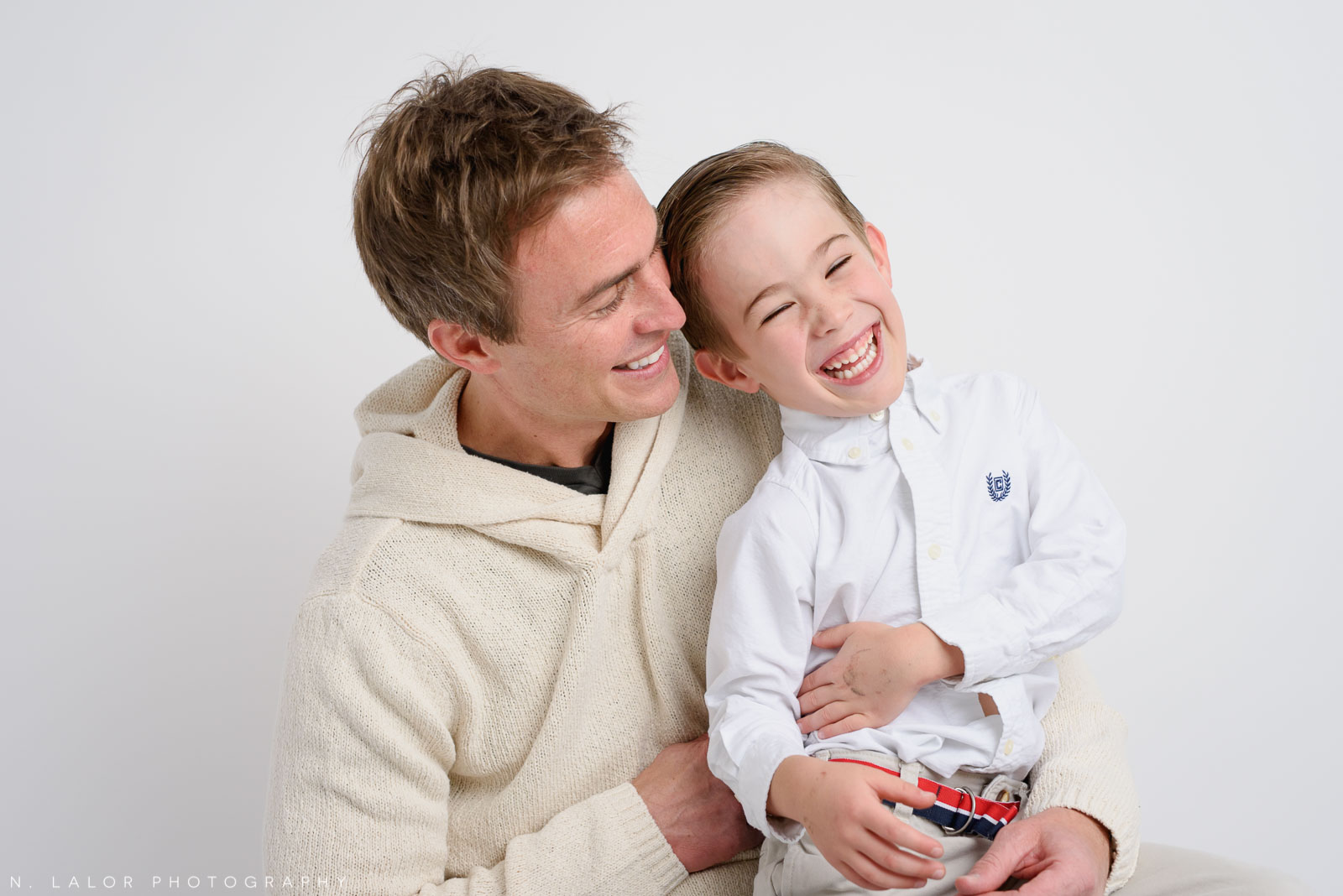 Dad and son, a candid moment. Studio family photoshoot with N. Lalor Photography in Riverside, Connecticut.