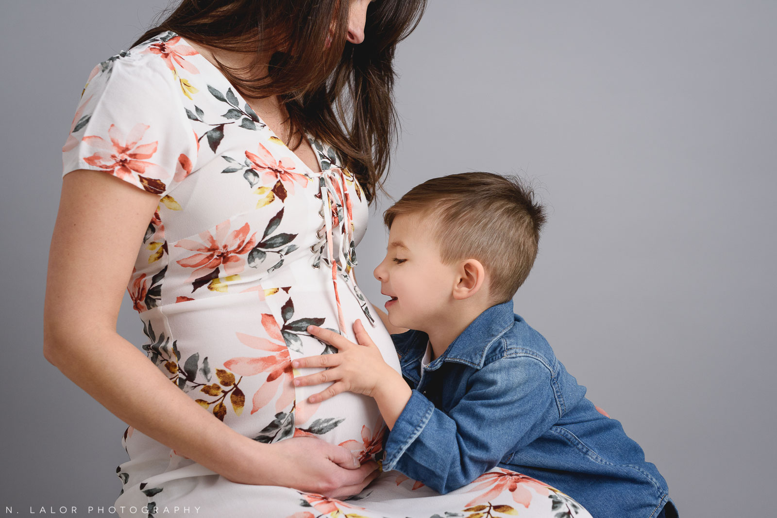 Older brother kissing Mom's tummy. Maternity + Family studio photoshoot with N. Lalor Photography, Greenwich Connecticut.