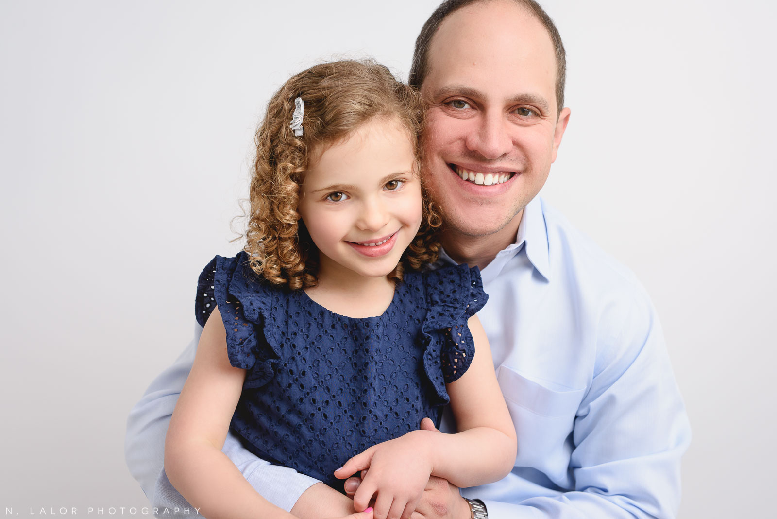 Dad with his daughter. Studio family photo session with N. Lalor Photography in Greenwich, Connecticut.