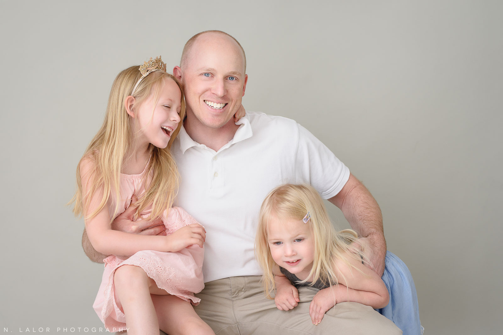 Dad with his daughters. Family photo session with N. Lalor Photography. Greenwich, Connecticut studio photographer.