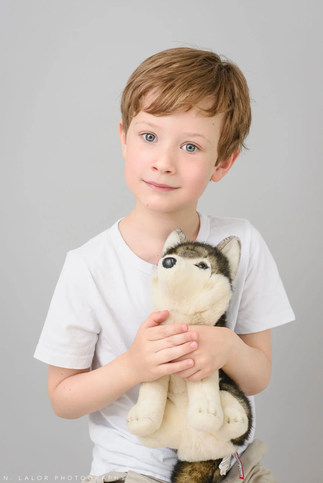 Boy with his favorite toy, Arctic Dog. Simple studio portrait session with N. Lalor Photography in Greenwich, CT.
