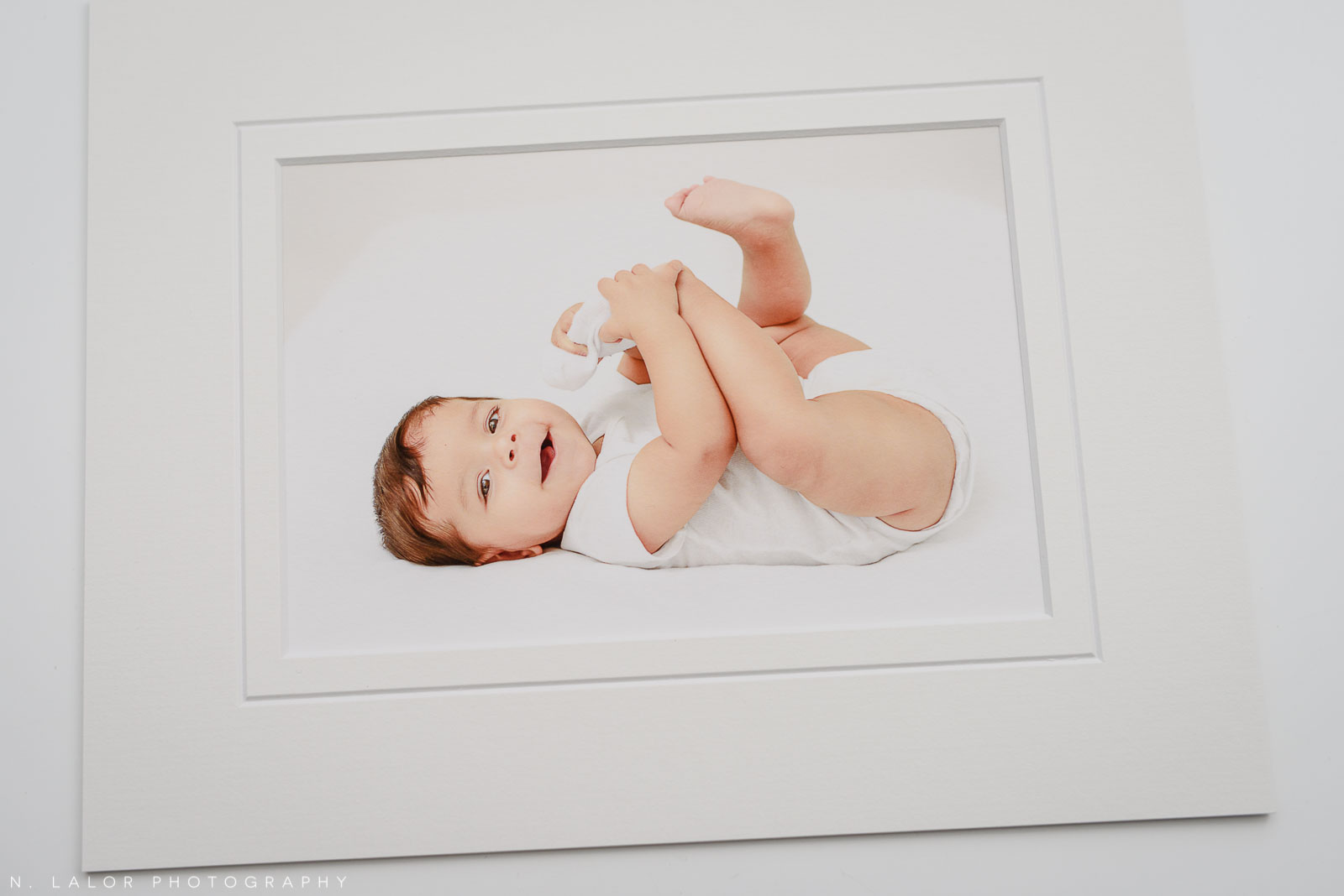 Playing with a sock. Studio baby photo session with N. Lalor Photography. Greenwich, Connecticut.