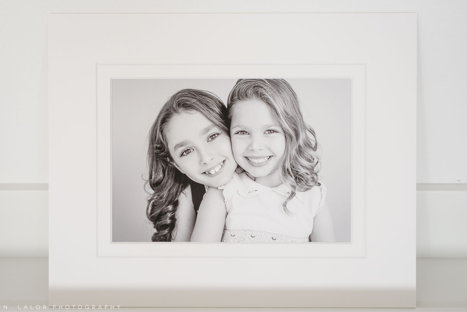 Sisters. Family photoshoot by N. Lalor Photography in Greenwich, Connecticut.