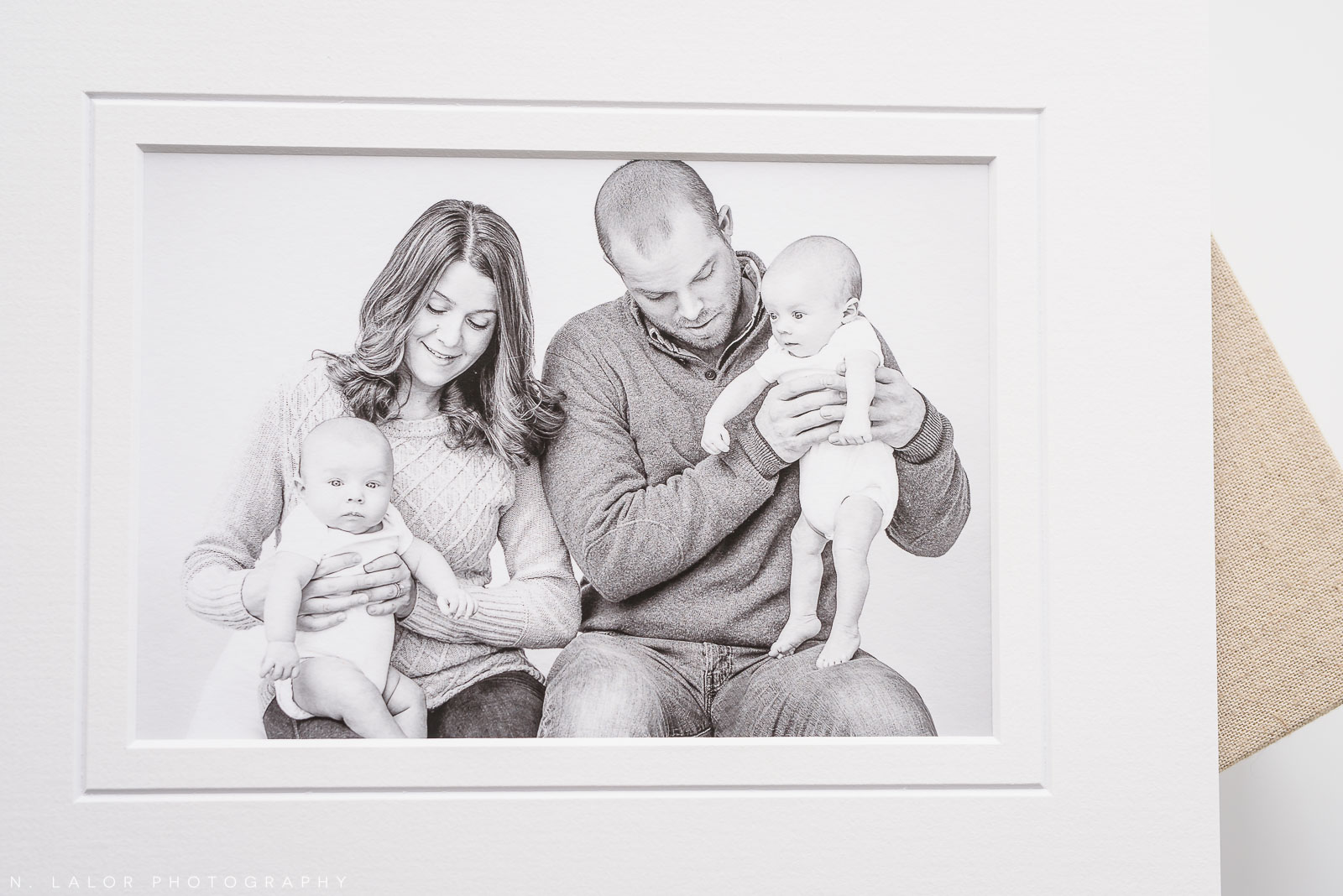 Candid family photo, fine art print. Twin newborn photo session by N. Lalor Photography. Greenwich, Connecticut.