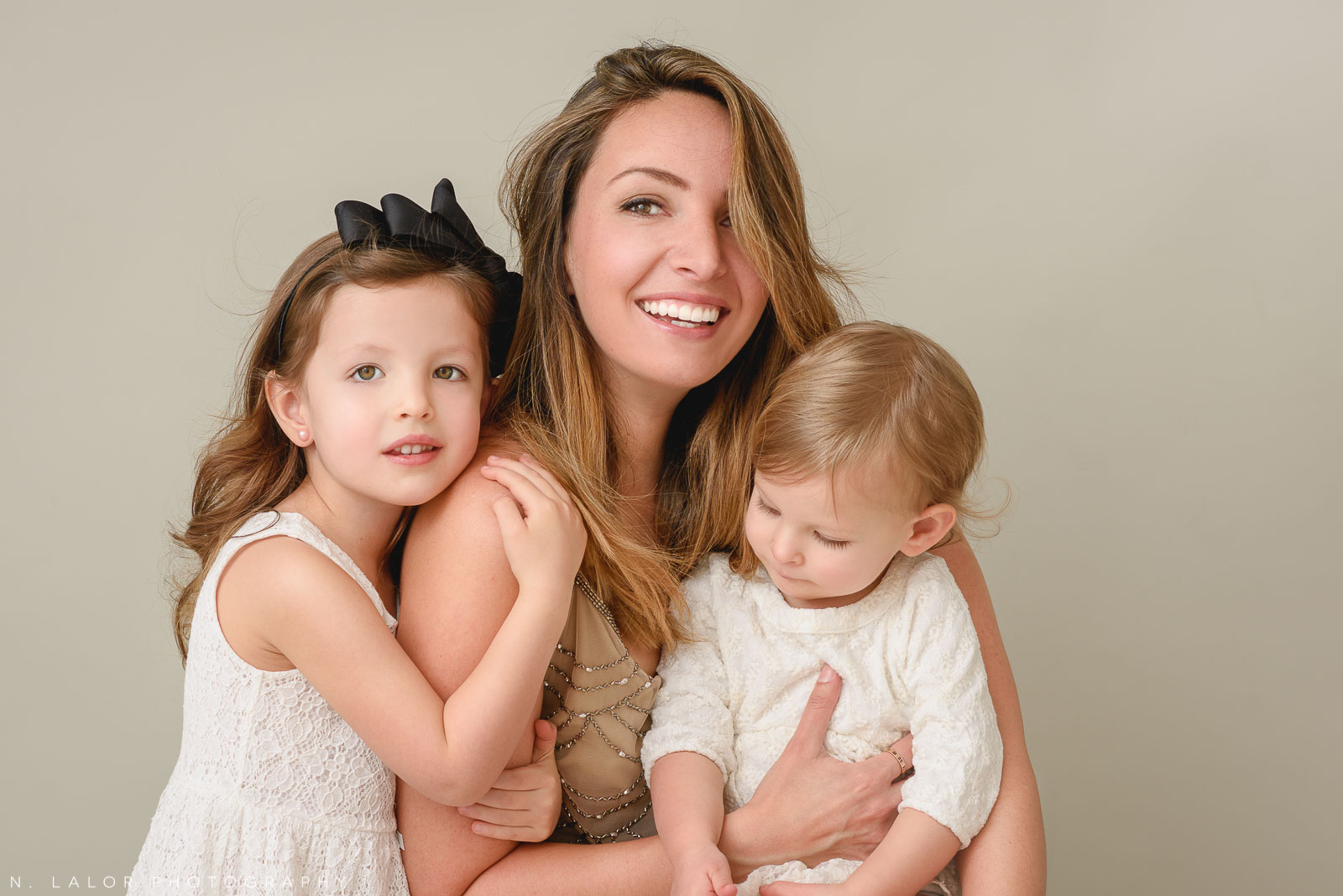 Casual portrait of Mom and her two girls. A Mother and Daughter photoshoot with N. Lalor Photography in Greenwich, Connecticut.
