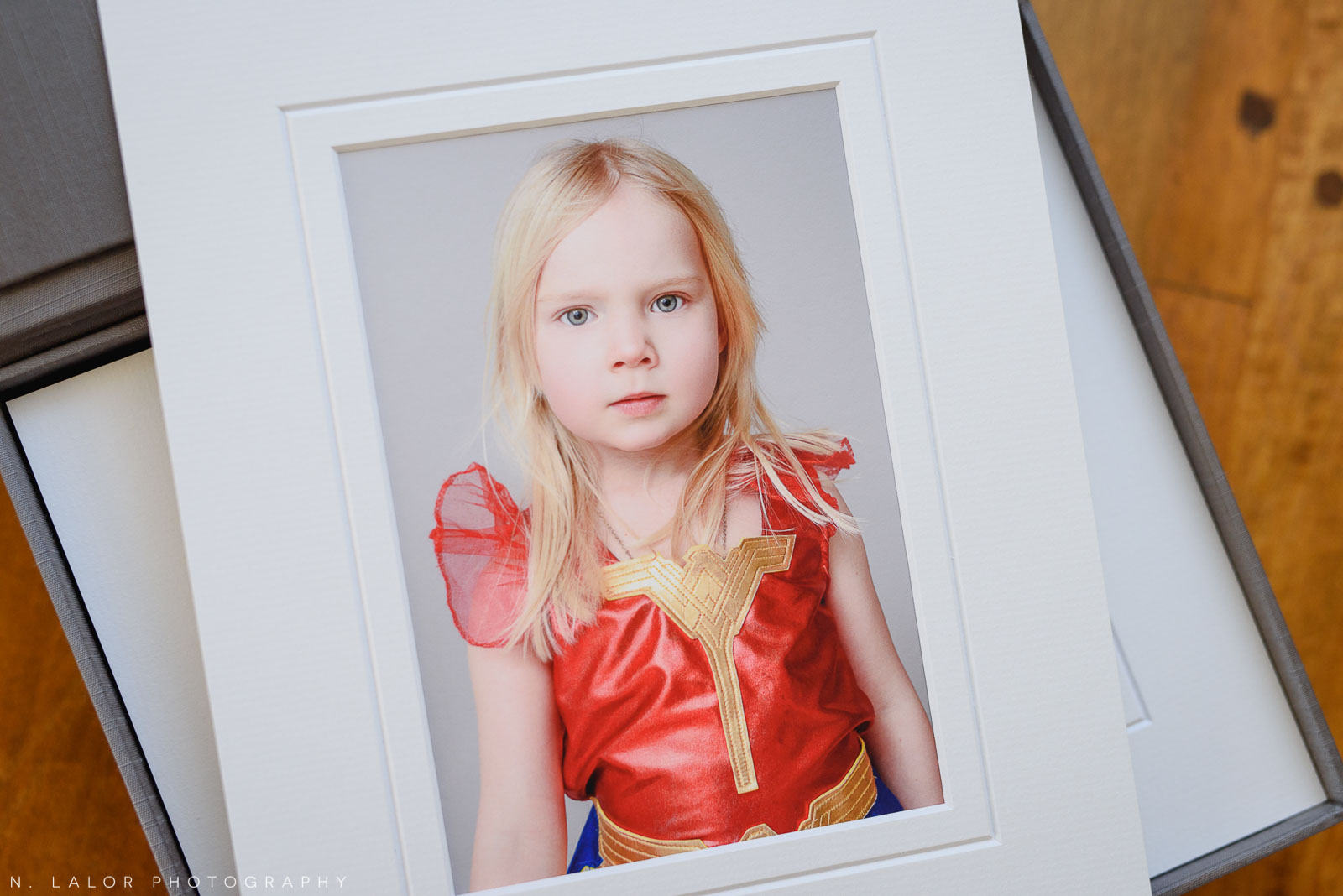 Portrait of a little girl dresses as Wonder Woman. Family portrait session with N. Lalor Photography in Greenwich Connecticut.