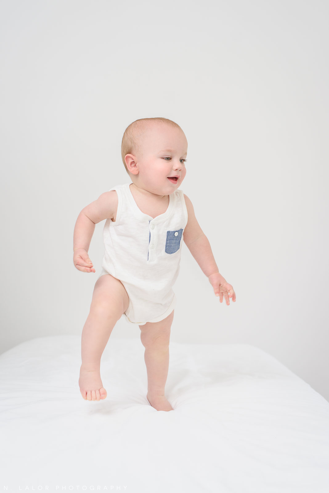 Walking. Studio baby milestone session with N. Lalor Photography in Greenwich, Connecticut.