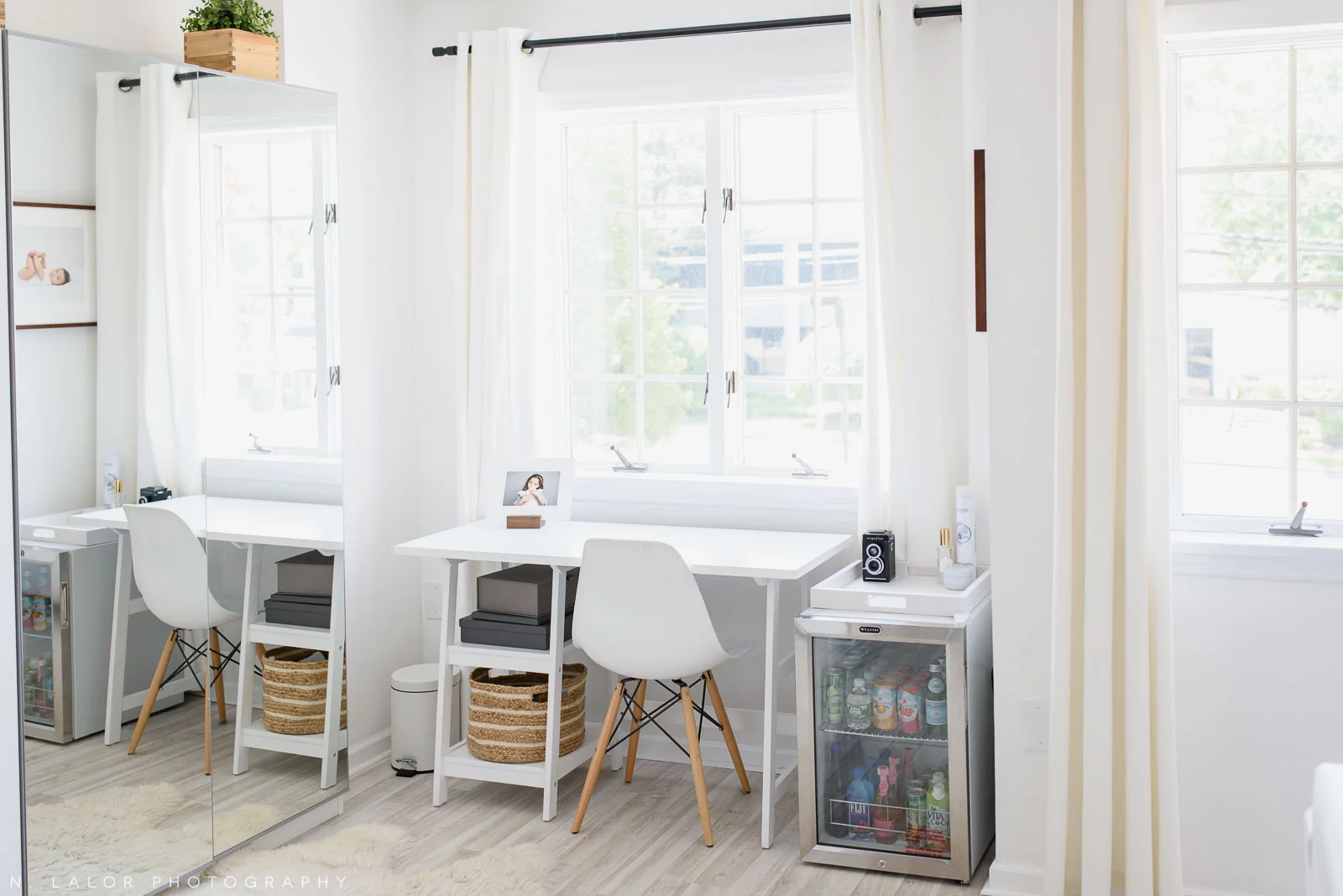 N. Lalor Photography Studio - work area with white table and mini fridge.