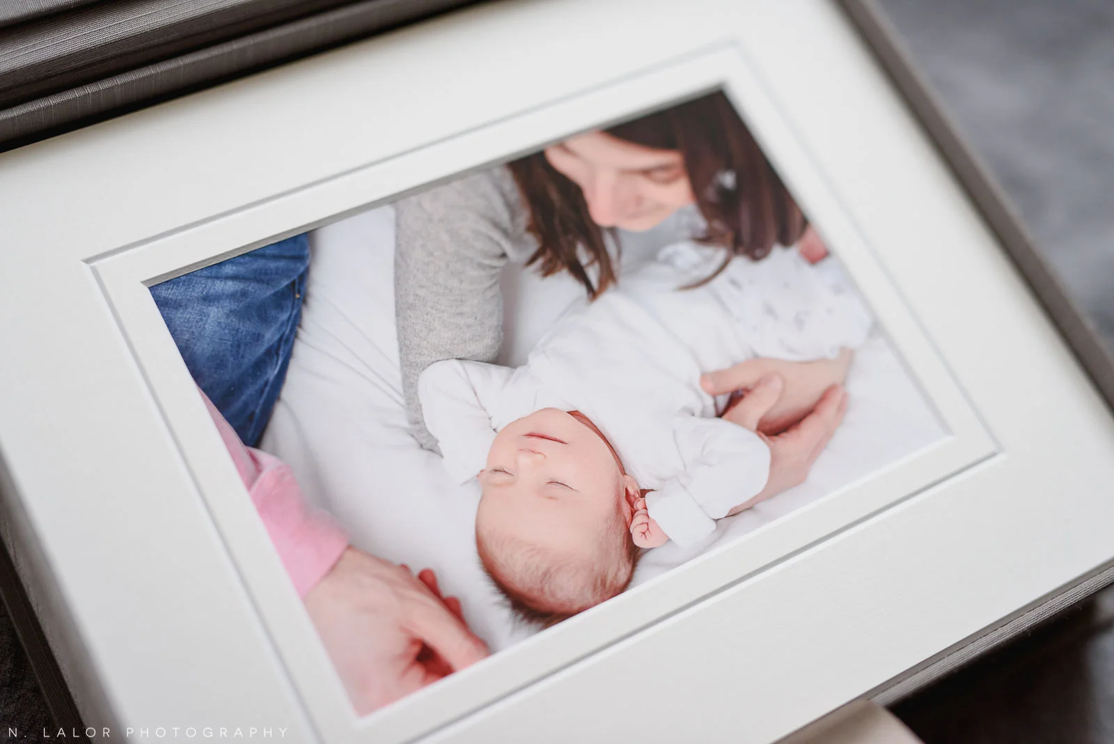 Image of a candid newborn portrait, printed and matted. Studio portrait by N. Lalor Photography in Greenwich, Connecticut.