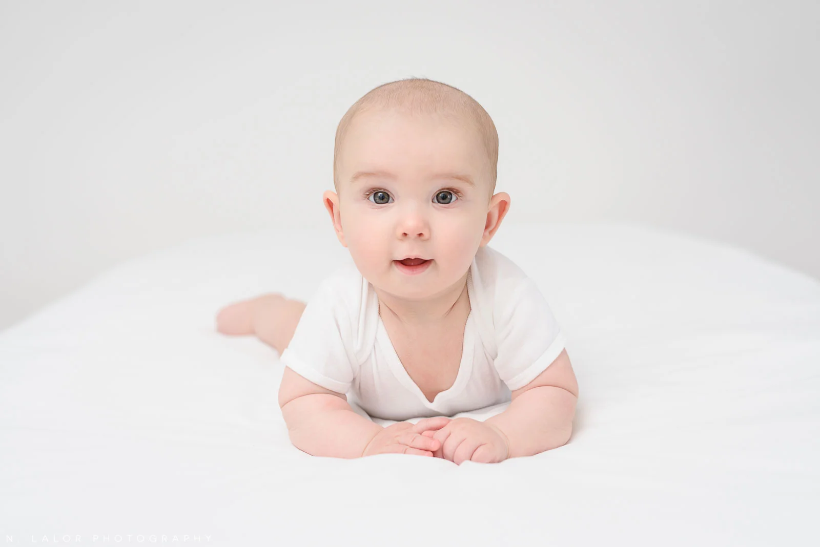 Photograph of a 3-month old baby in a simple and clean style. Studio portrait by N. Lalor Photography in Greenwich Connecticut.