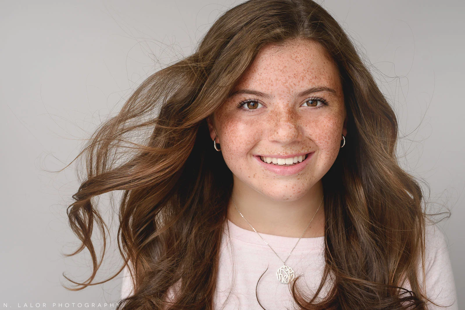 Headshot of a young girl with freckles. Studio portrait by N. Lalor Photography. Greenwich, Connecticut.