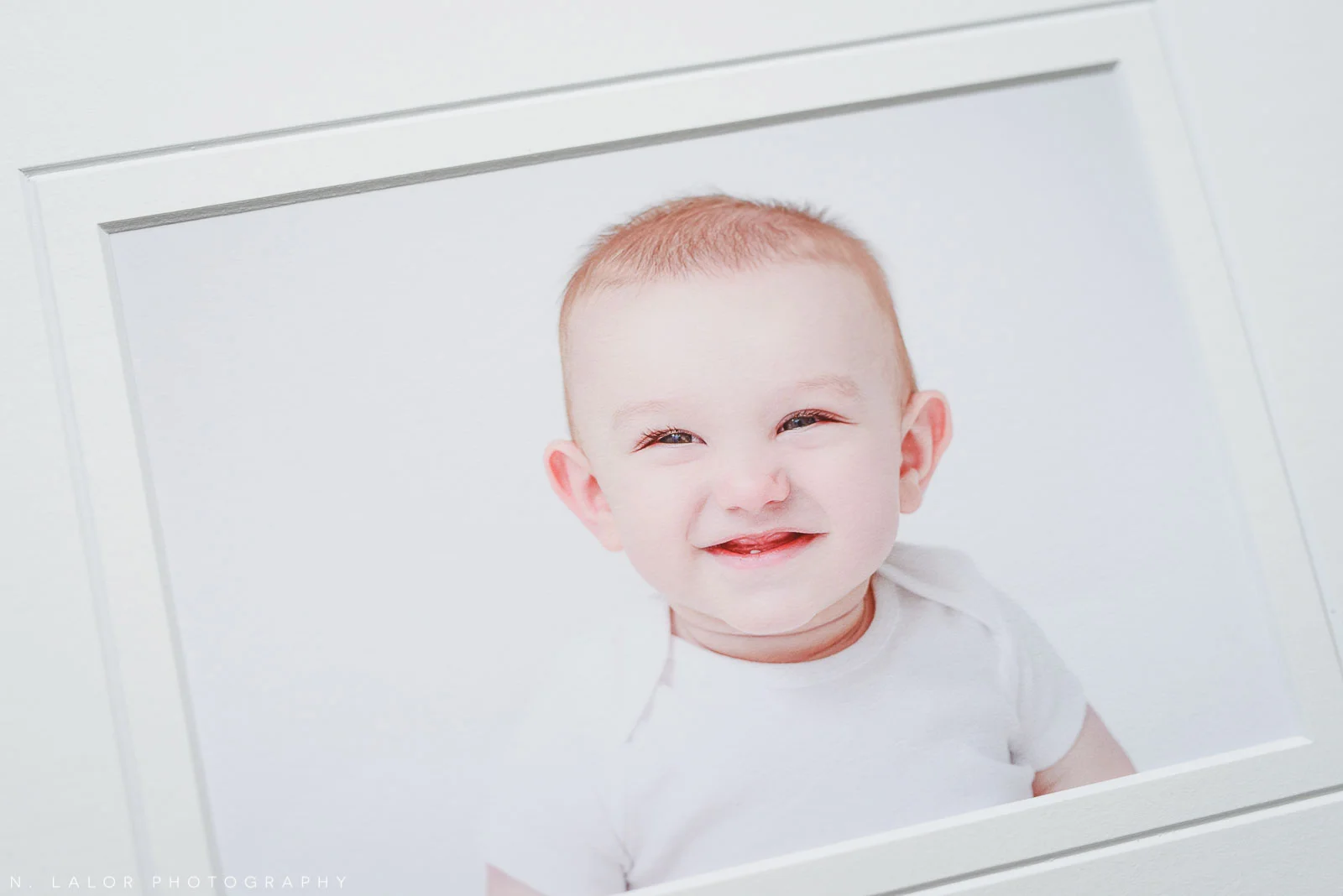 Image of a museum-quality print. Portrait of a smiling baby by N. Lalor Photography in Greenwich Connecticut.