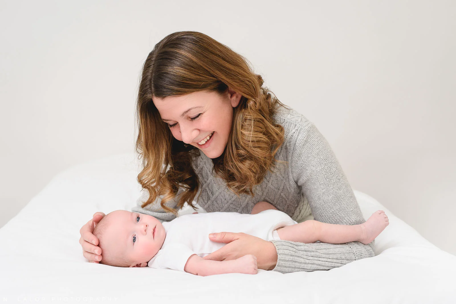 Image of a new Mom with her baby boy in a casual Studio setting. Studio portrait by N. Lalor Photography in Greenwich, Connecticut.
