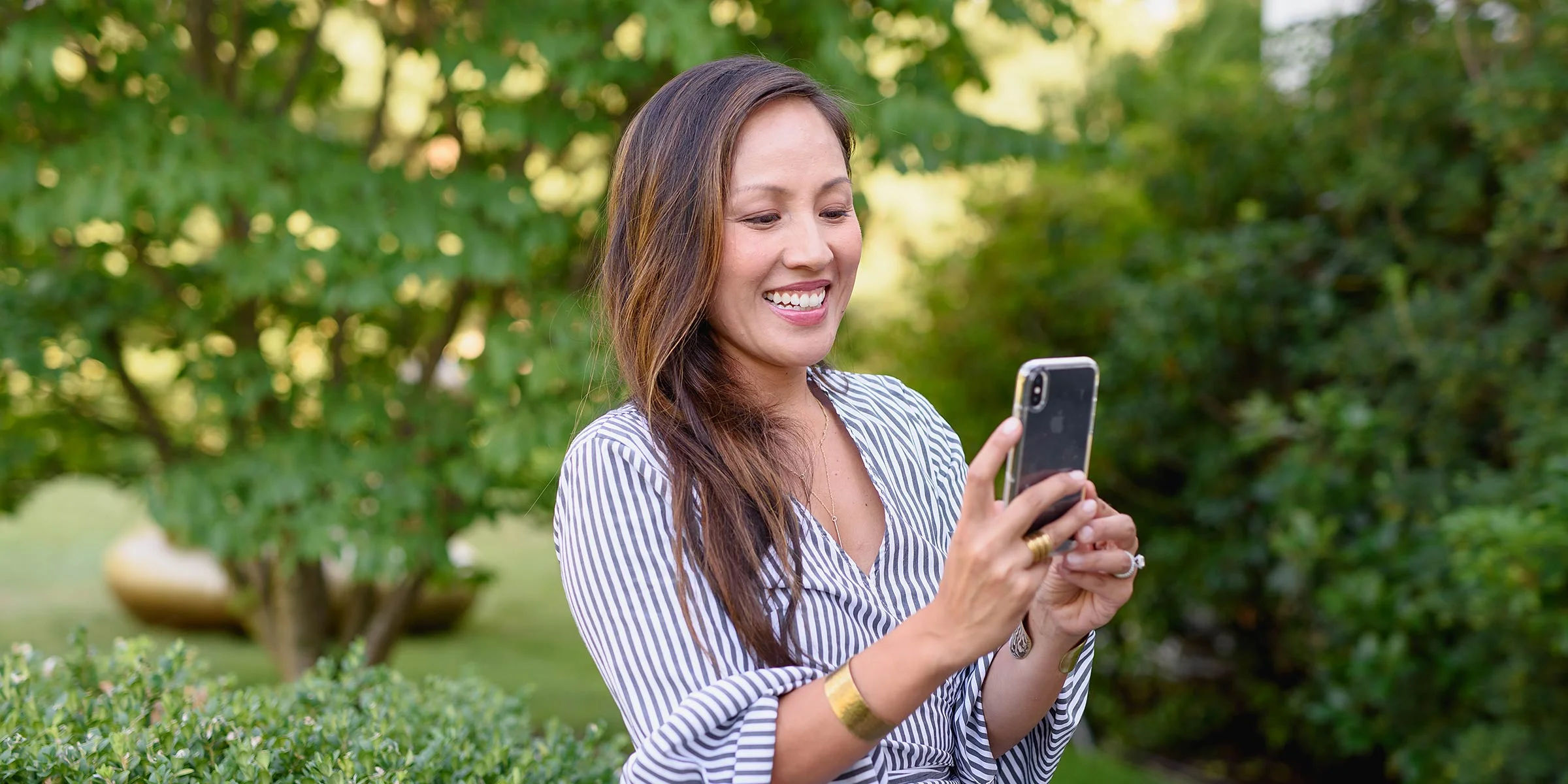 Image of an entrepreneur taking a photograph for her Instagram feed. Personal Branding portrait by N. Lalor Photography.