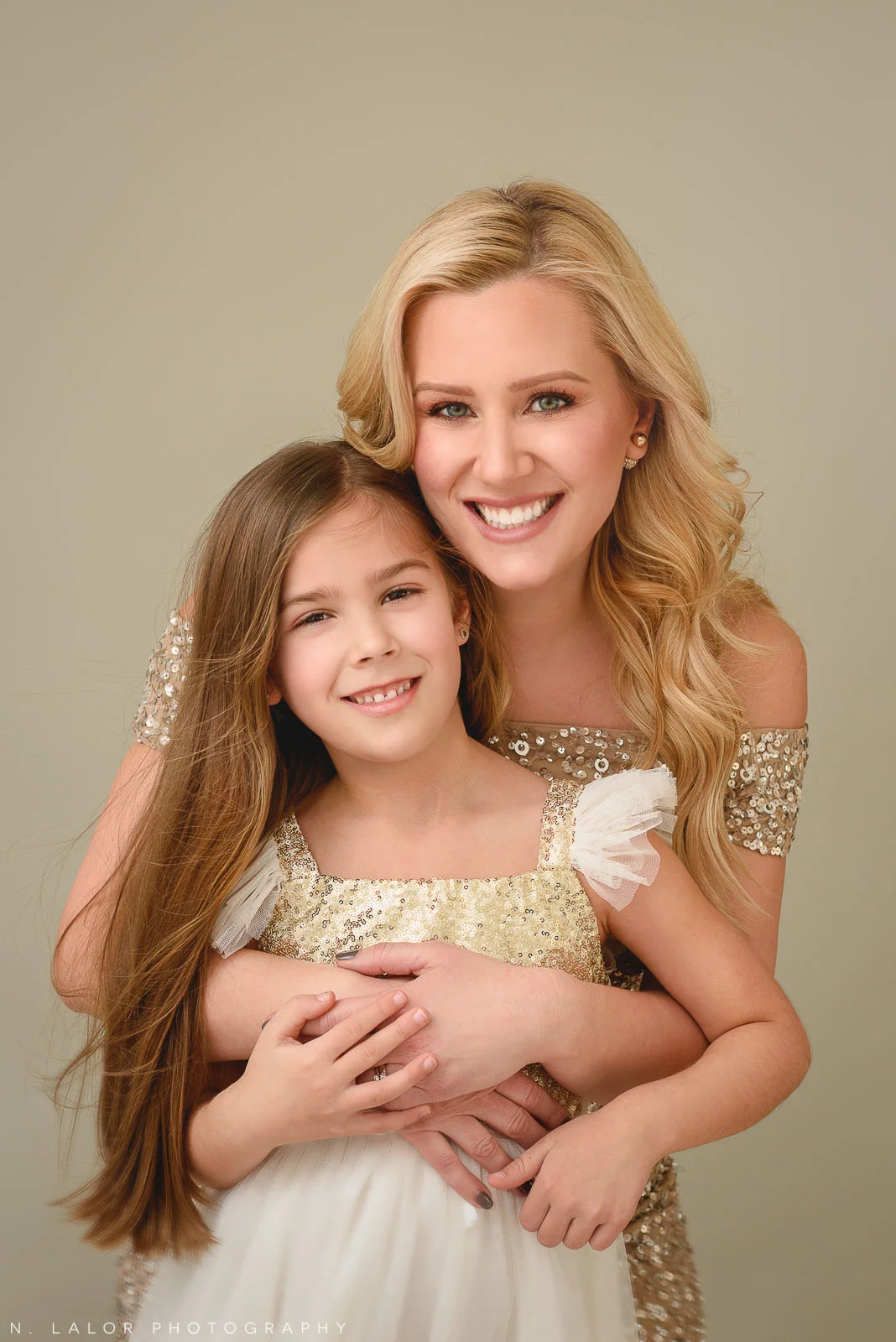 Image of a Mother and daughter hugging. Studio family portrait by N. Lalor Photography in Greenwich Connecticut.