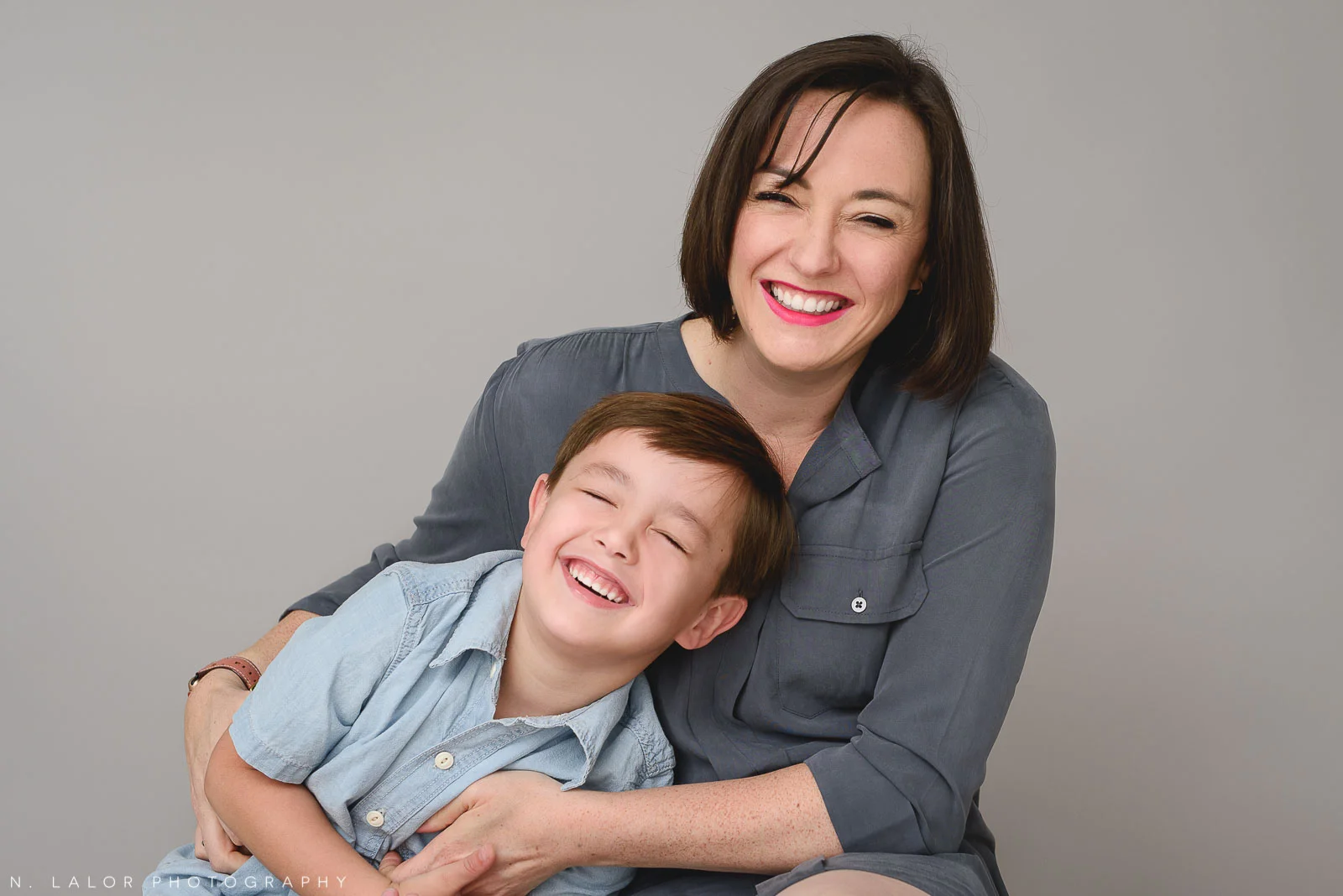 Image of a Mom laughing with her son. Studio family portrait by N. Lalor Photography in Greenwich Connecticut.