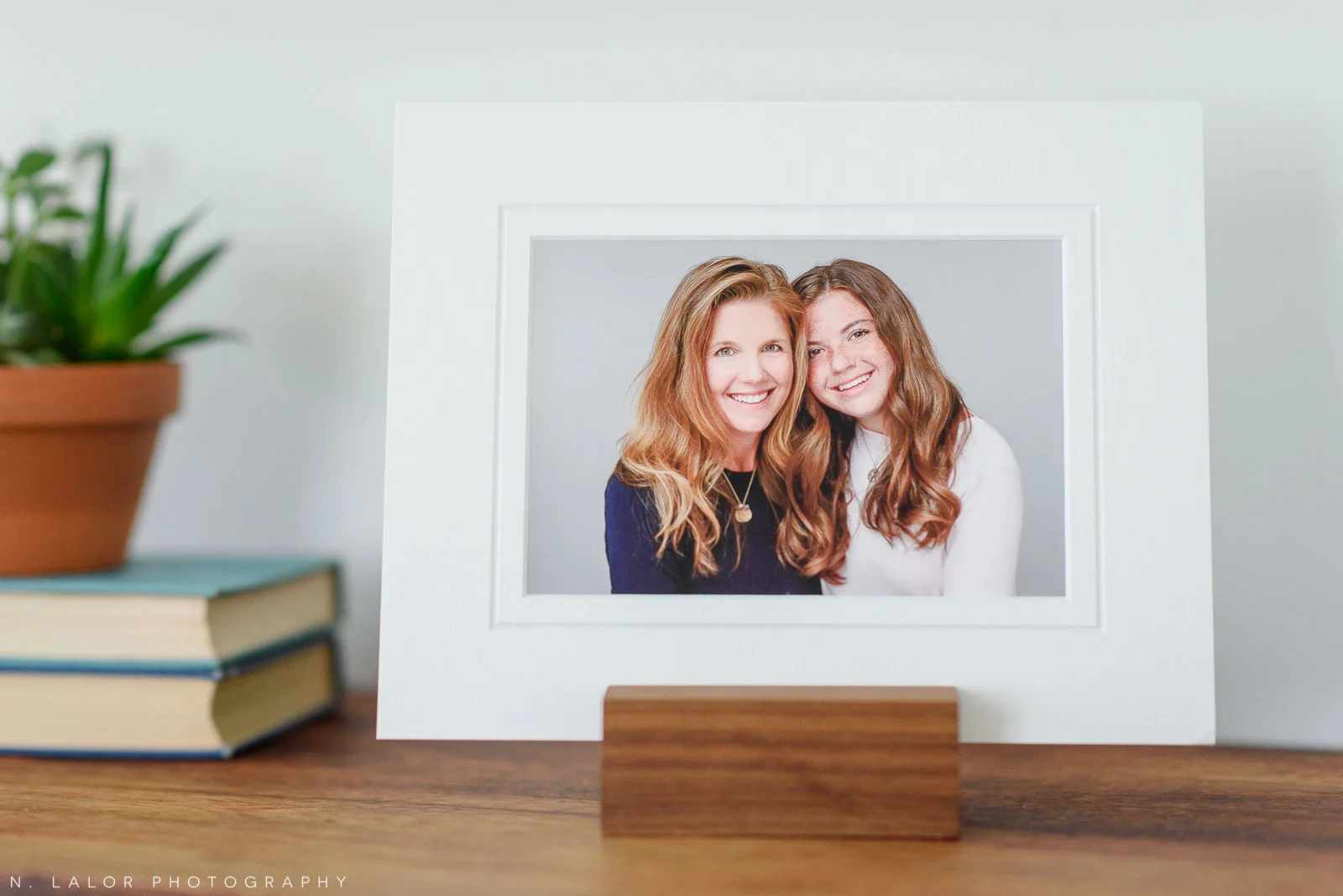 Image of a matted FineArt print of a Mom and her daughter, displayed on a tabletop using a photo stand. Studio portrait by N. Lalor Photography in Greenwich, Connecticut.