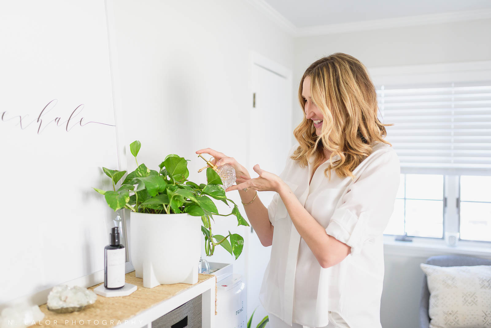 Mary watering plants in her Studio. Mary Heaven Acupuncture in Greenwich, CT.