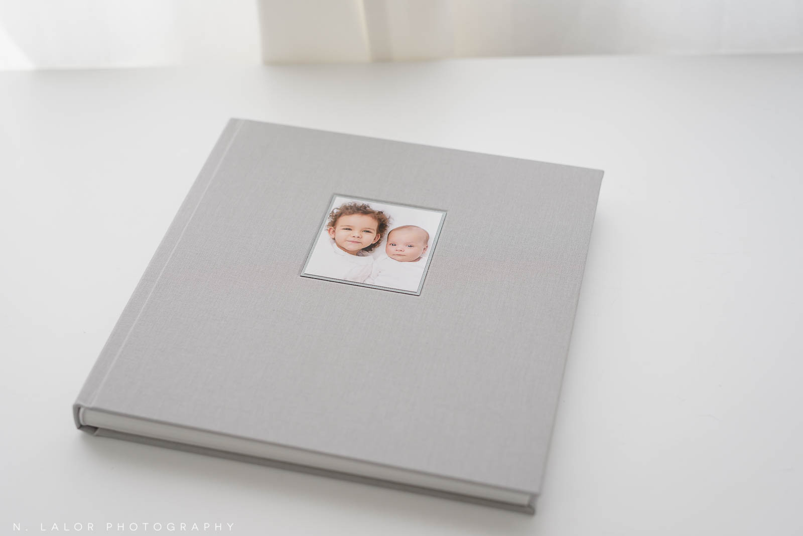 Image of a photo album by family portrait photographer N. Lalor Photography in Greenwich Connecticut.