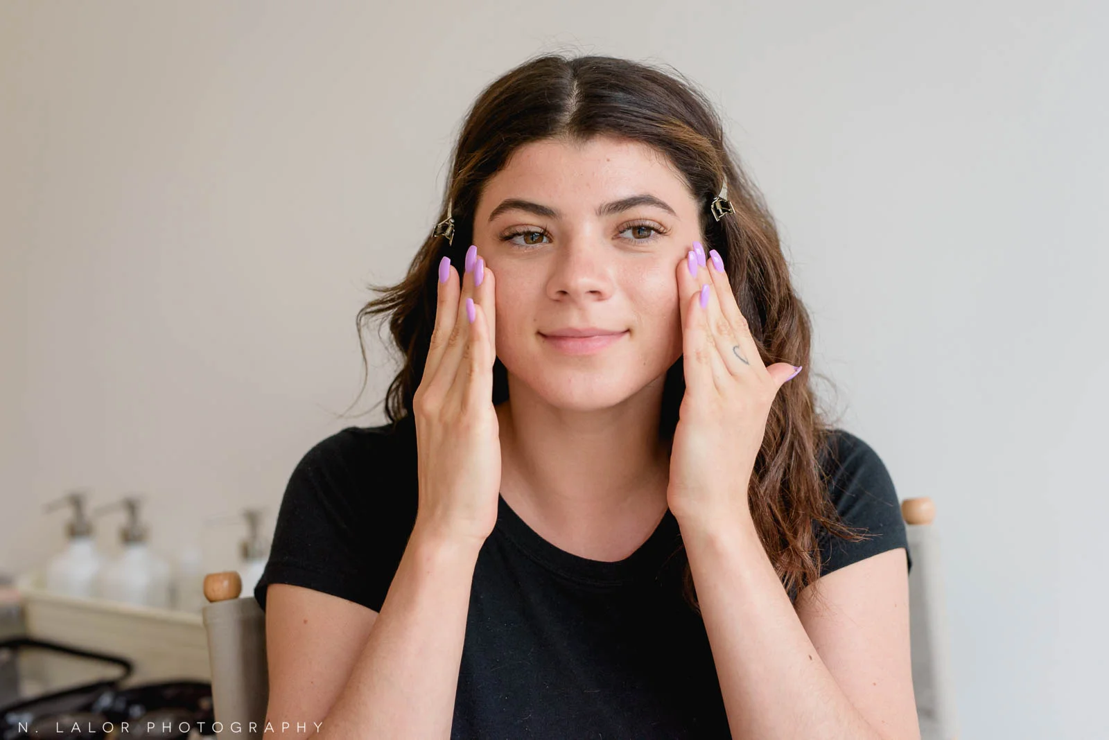 Makeup tutorial for photoshoots, applying moisturizer to skin is the first step. Photo by N. Lalor Photography, makeup tips by Haus of Pretty of Westport CT.