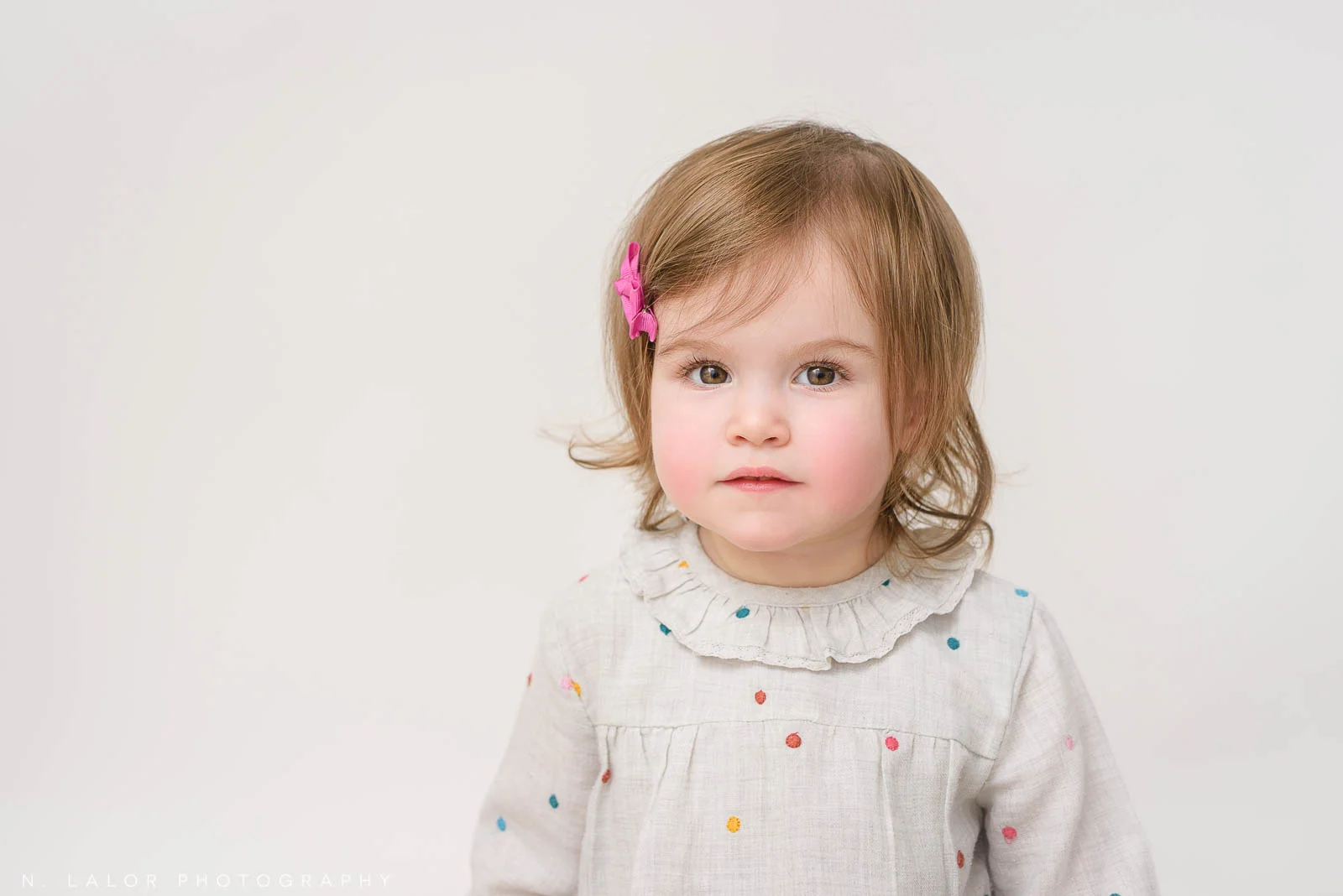 Even children need a bit of retouching! In this image, the under eye area was lightened and skin was retouched to create a non-distracting portrait of how her Mom sees her every day.