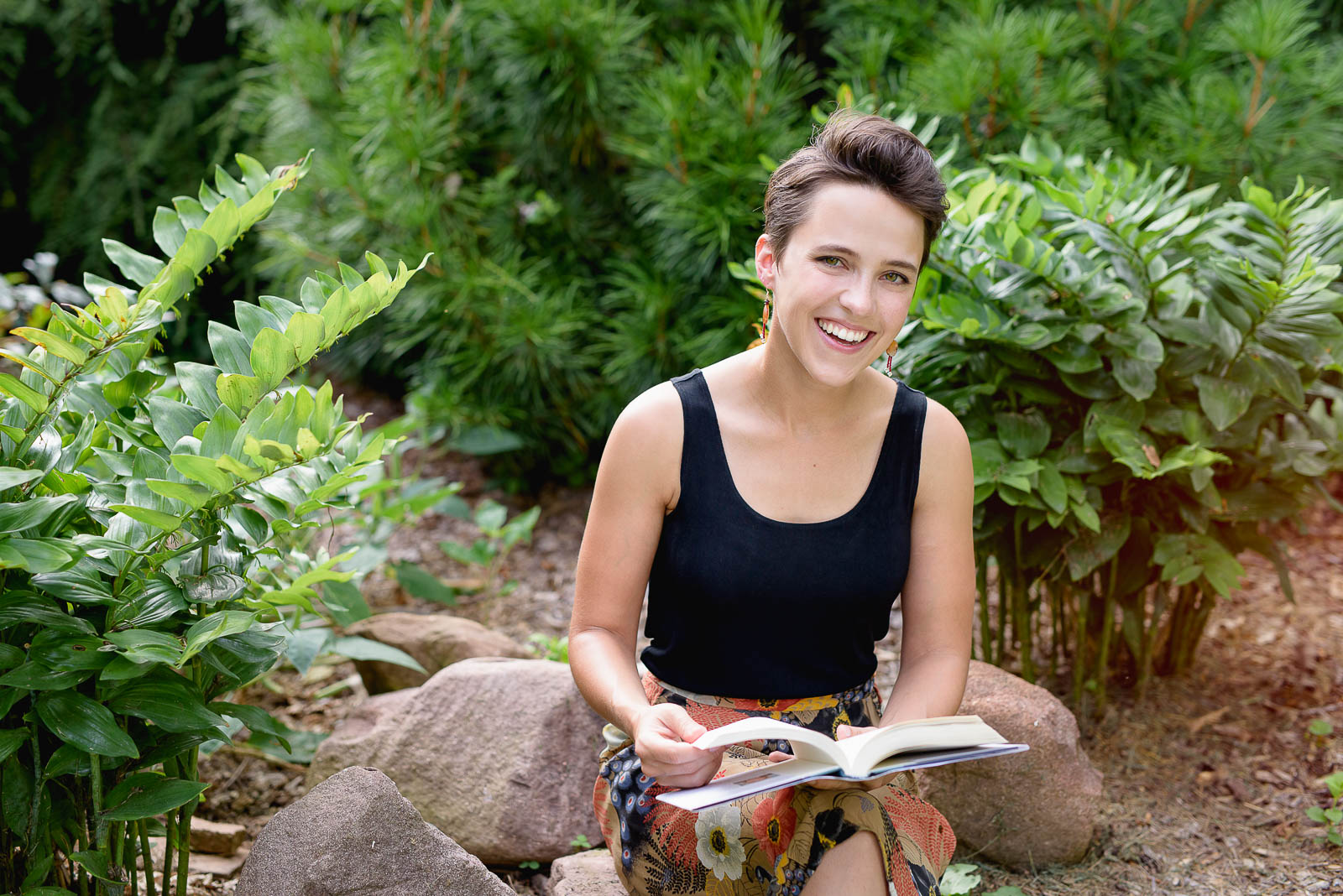 Image of woman with book in nature during Session Spotlight. Business headshot by N. Lalor Photography. Studio in Greenwich, Connecticut.