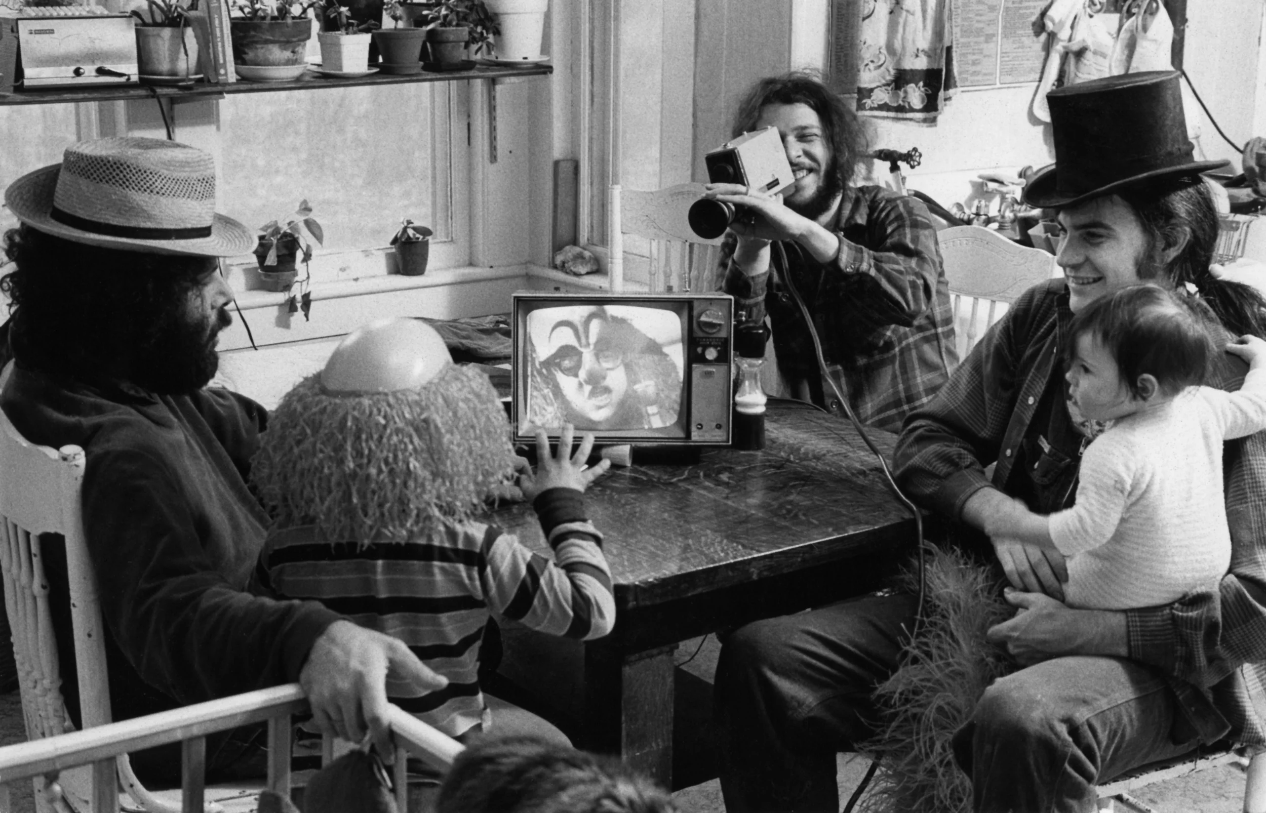 John Domnis, Detail of Videofreex (l. to r.) David Cort, Bart Friedman, and Parry Teasdale (holding Sarah Teasdale) introduce Lanesville, NY resident Scottie Benjamin to Sony Portapak technology at Maple Tree Farm, 1973. Gelatin silver print. Courtesy Videofreex.
