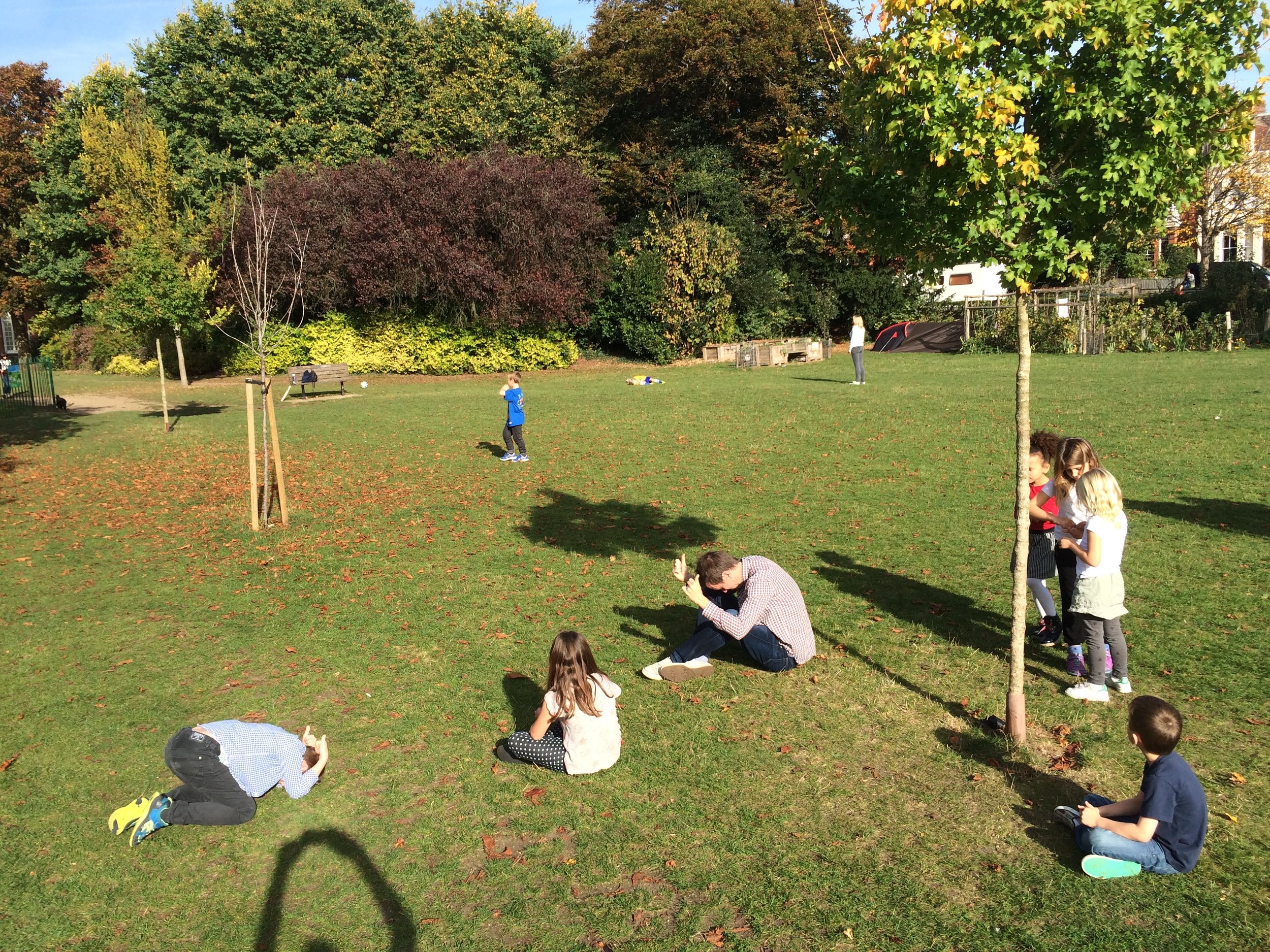 Playing 'Heads down, thumbs up' in the park.