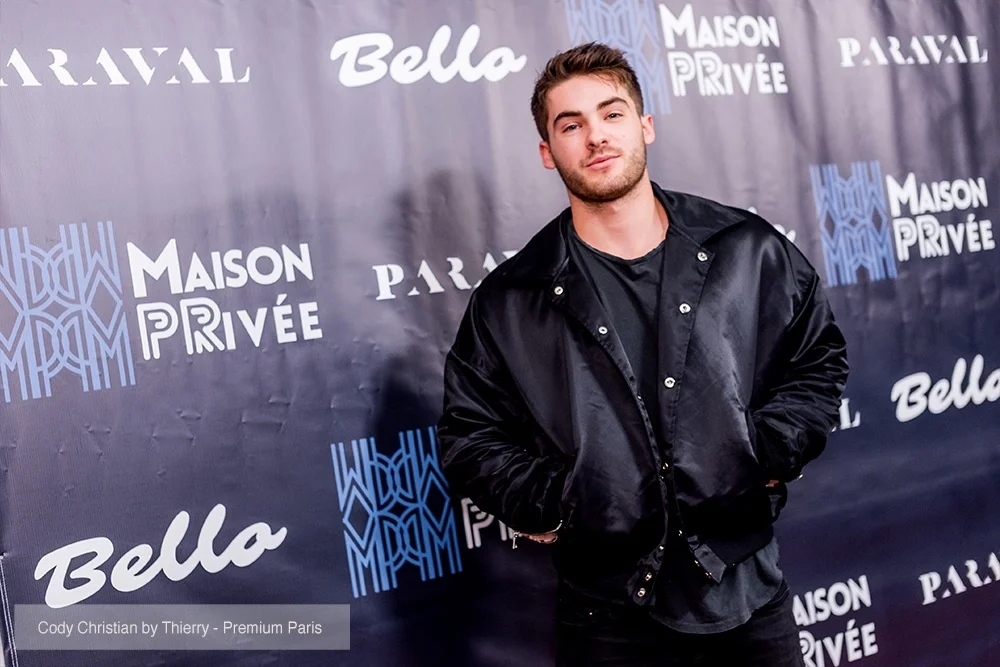 Actor Cody Christian attends the Bello and Maison Privee party at Hills Penthouse wearing jacket from Paraval (@paraval.us)