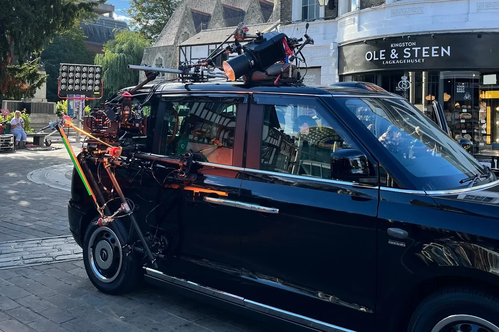 Close-up of professional external camera rigging and suction mounts on a London black cab tracking vehicle