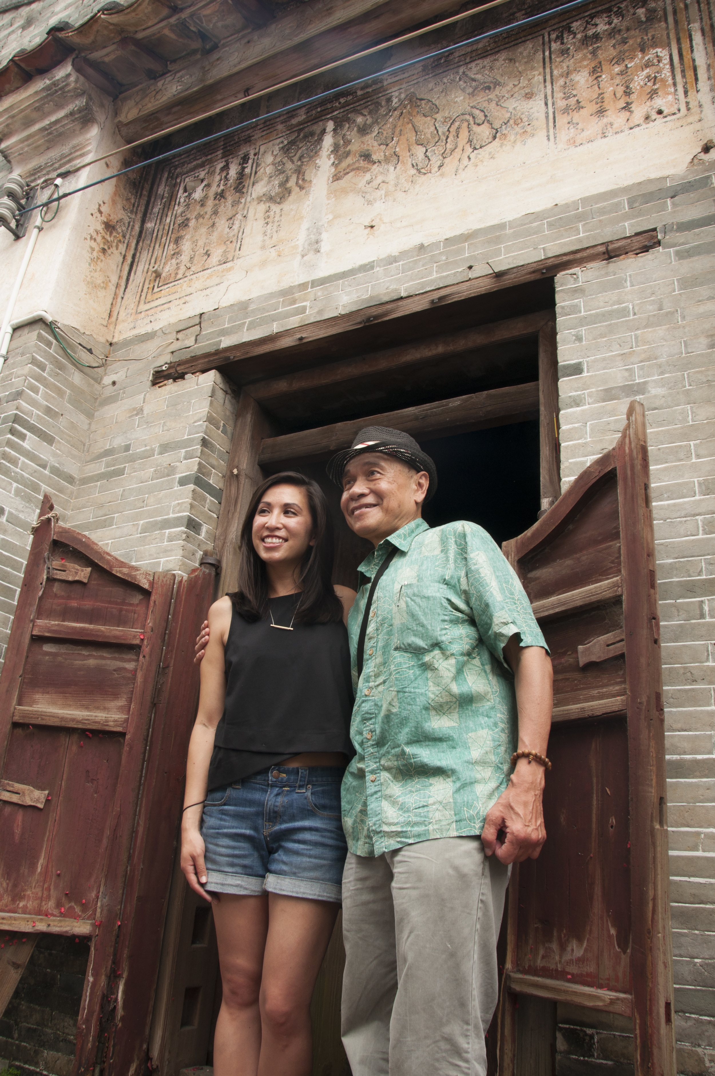 Michelle and Al Cheng in front of her ancestral home