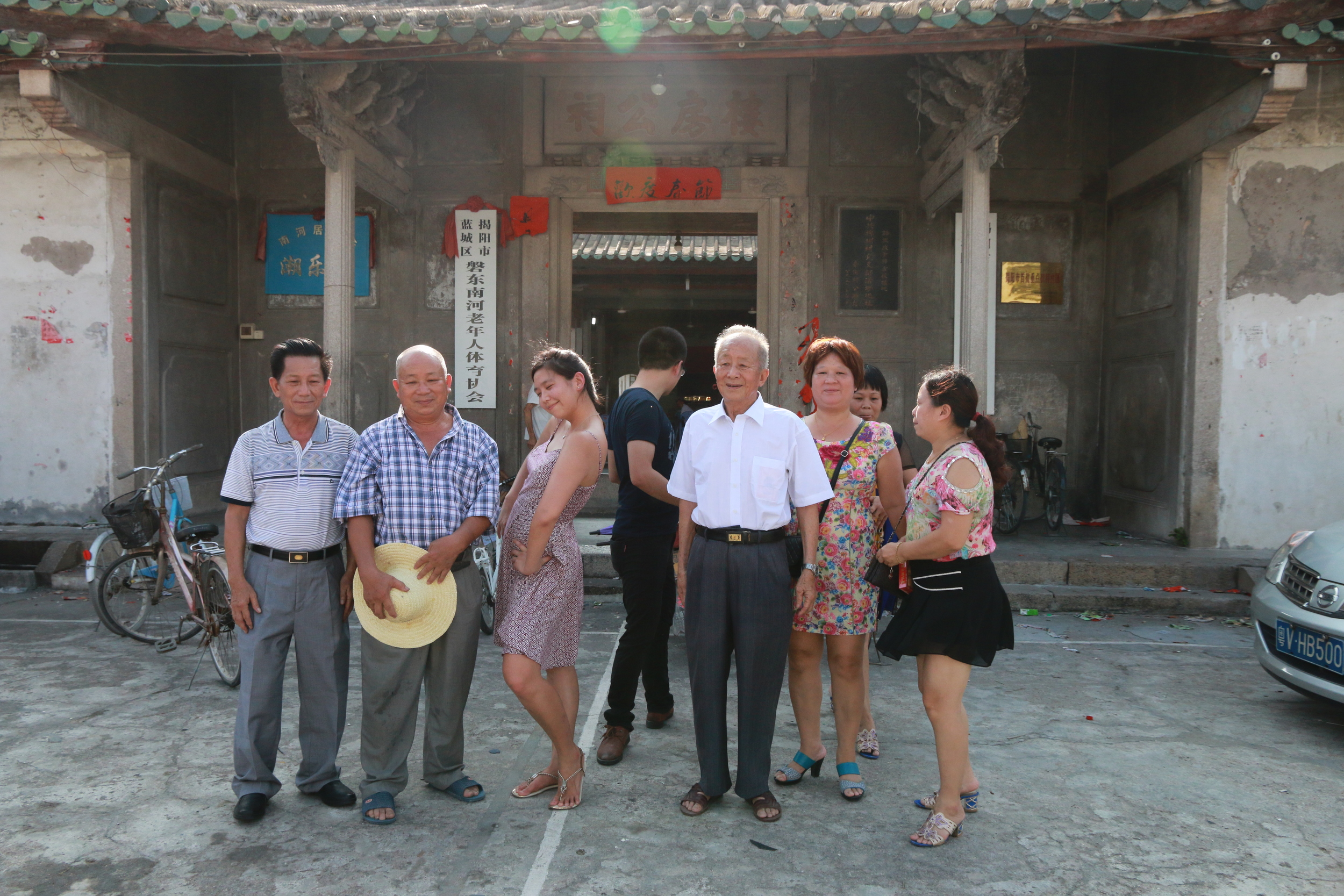 Getting ready for a family group photo in front of ancestral hall