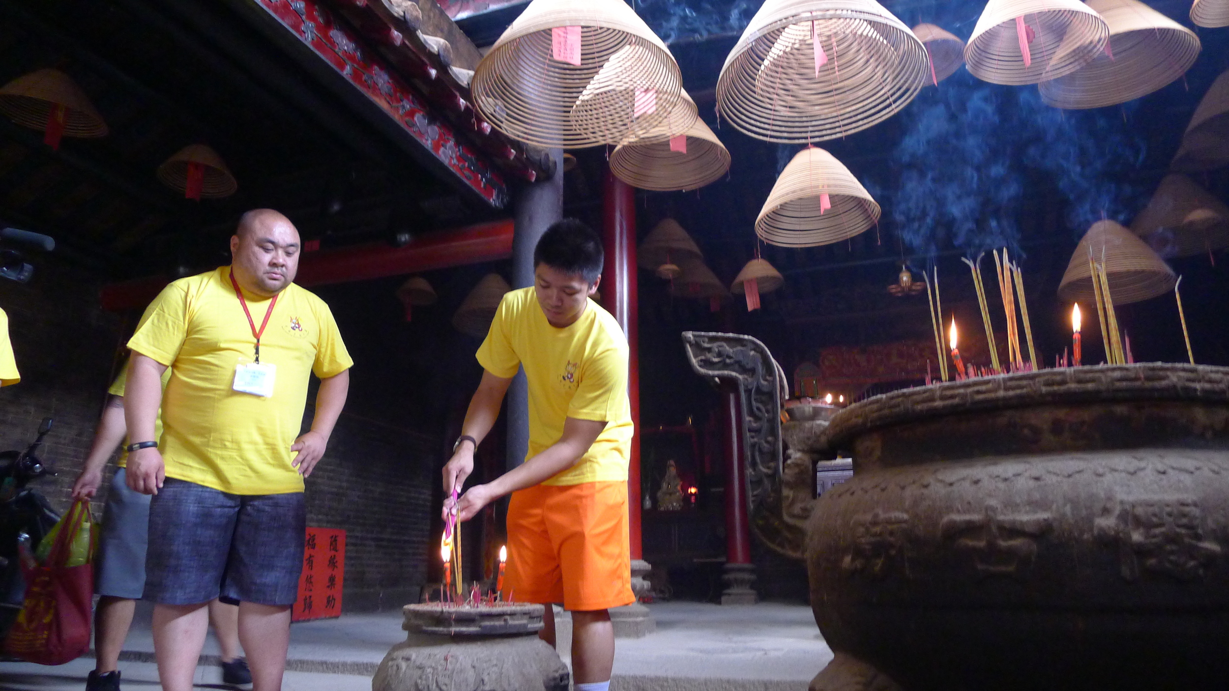 Lighting incense within the ancestral temple.