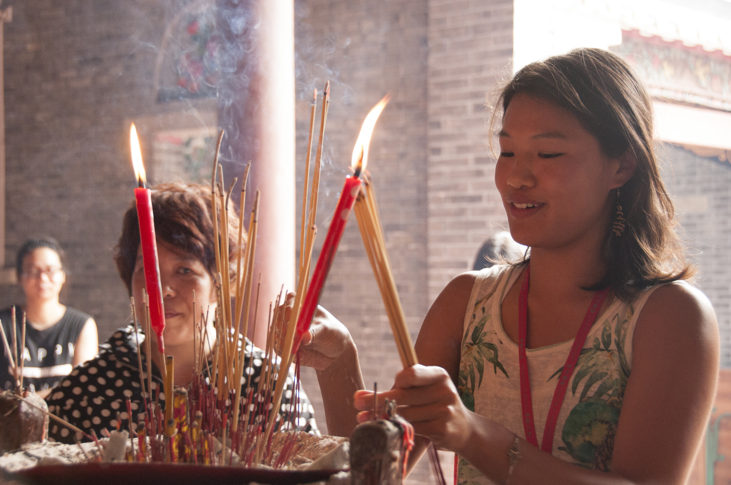 My aunt Ling Yi guides me as I place the incense.